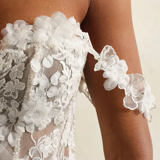 Kellen wedding gown bodice with floral lace and sheer tulle fabric, side view.