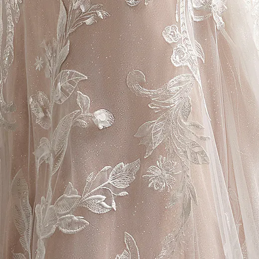 Chic Nyjah scalloped sparkling lace detail on wedding dress fabric.