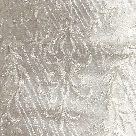 Beaded Sorrento Cat Eye Strapless Wedding Gown detail with sequined lace pattern.