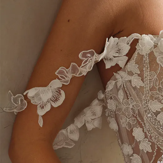 Maggie Sottero floral detail on sheer wedding dress with 3D floral straps.
