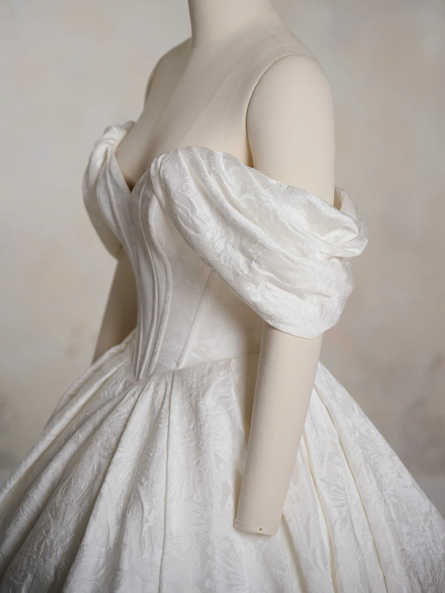 Maggie Sottero floral ball gown side view with off-shoulder puff sleeves
