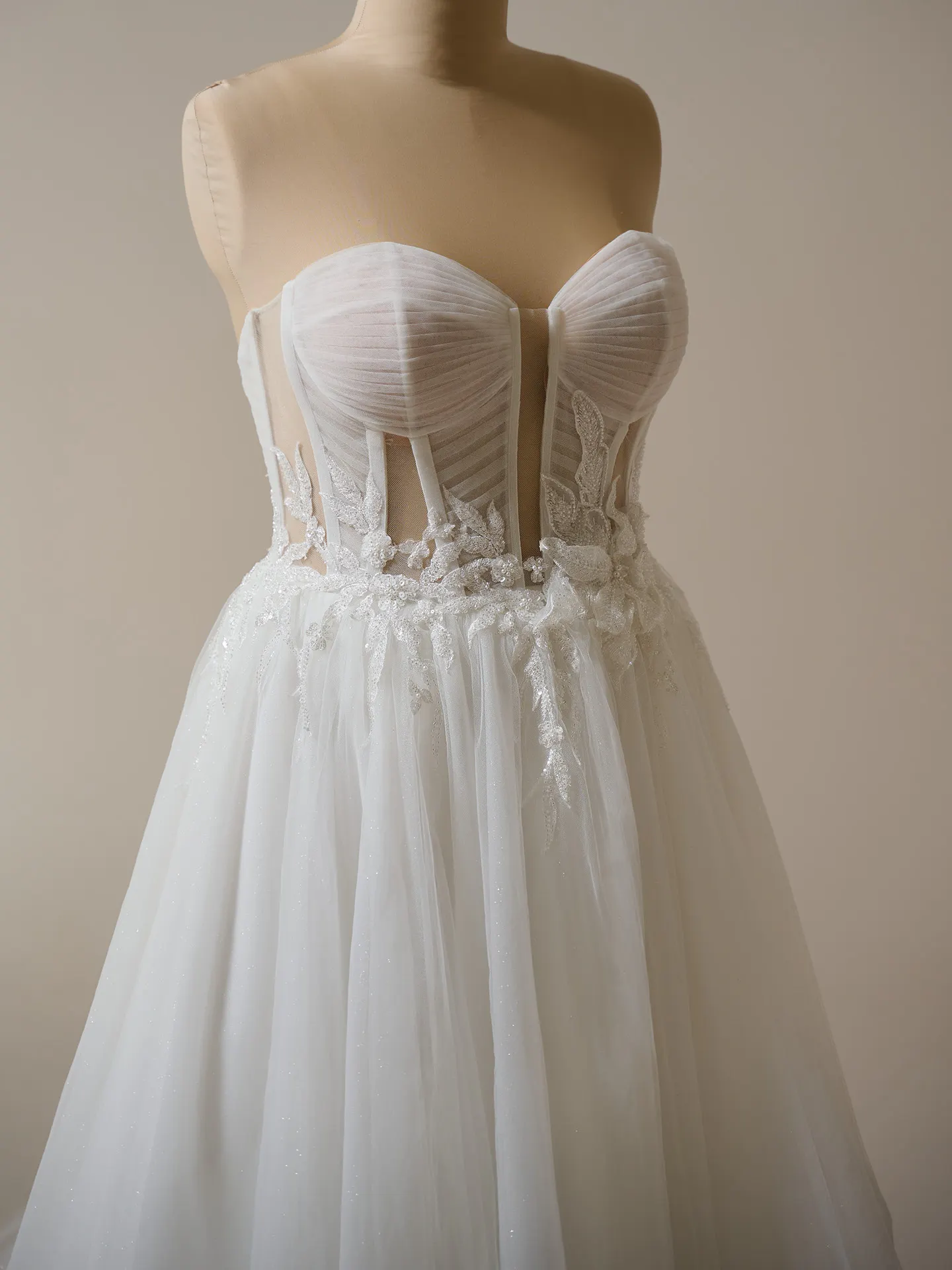 Maggie Sottero Arden front view illusion pleated A-line wedding dress.