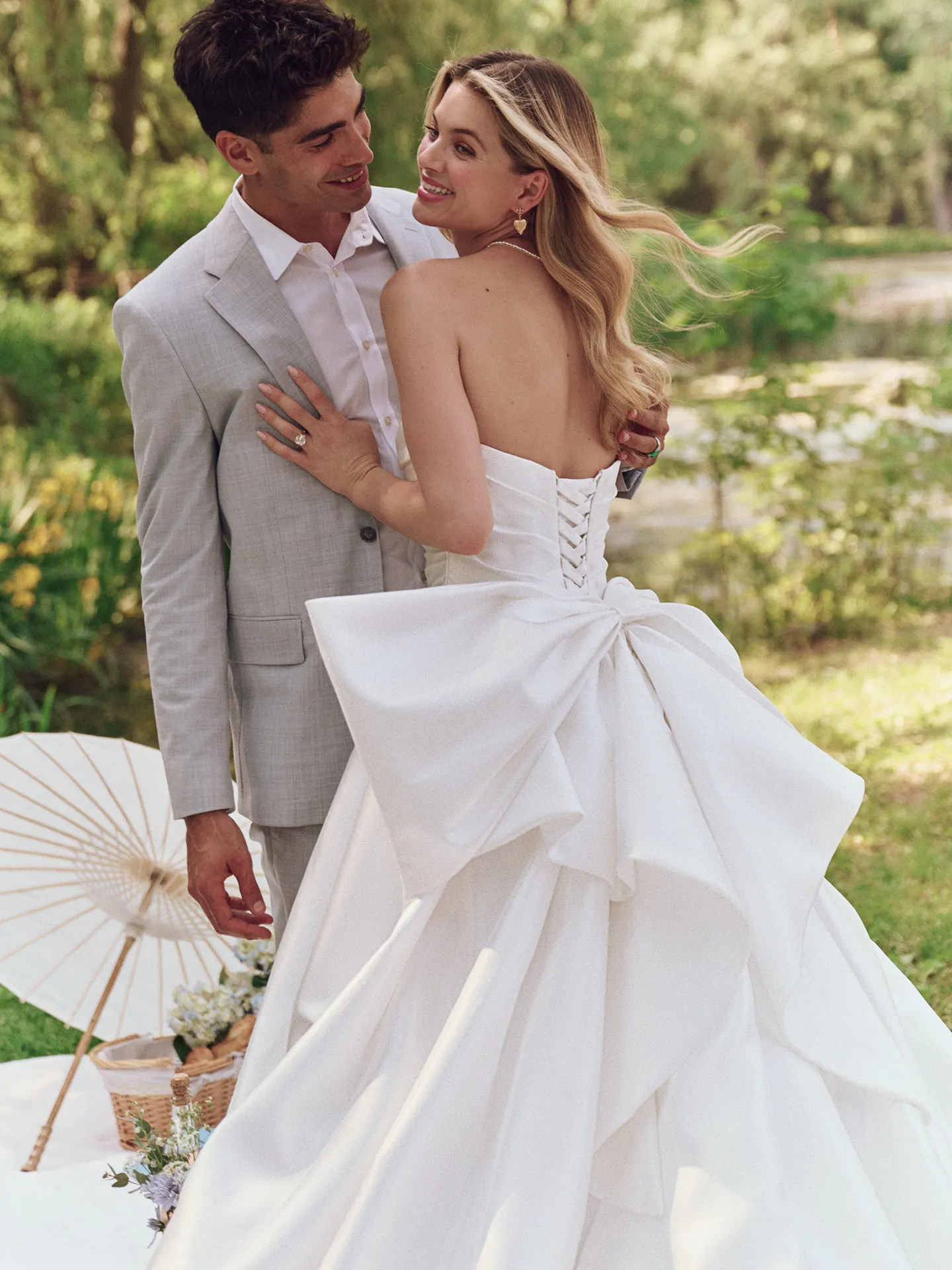 Aubrielle back view; textured satin ball gown with corset and large bow, Maggie Sottero.
