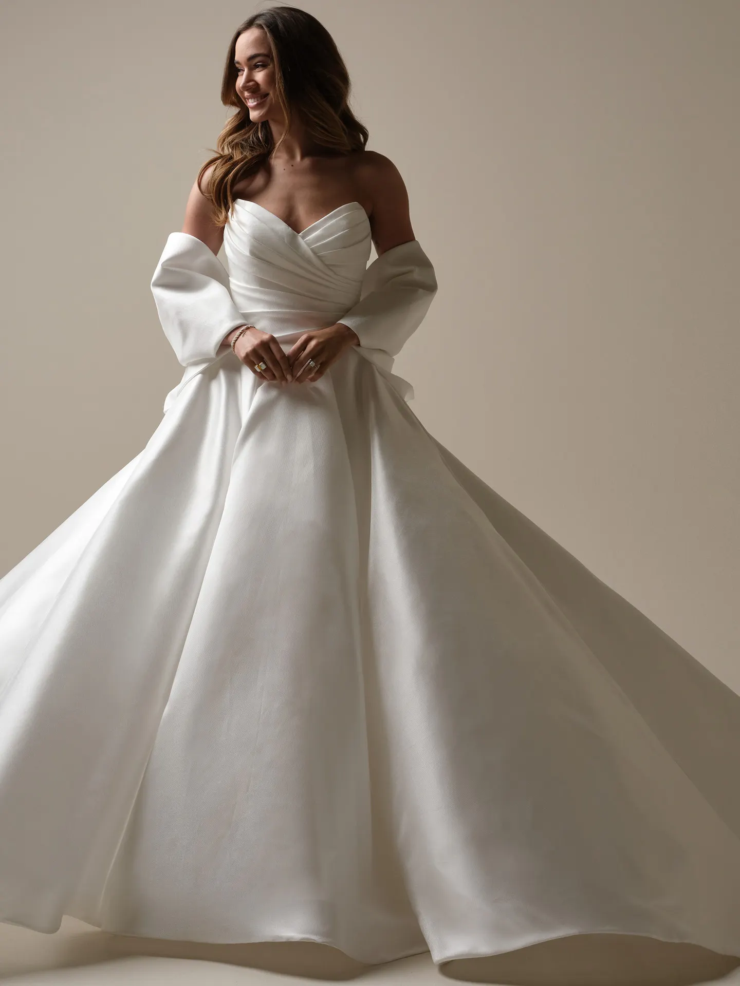 Maggie Sottero Aubrielle side view satin ballgown with detachable bow.