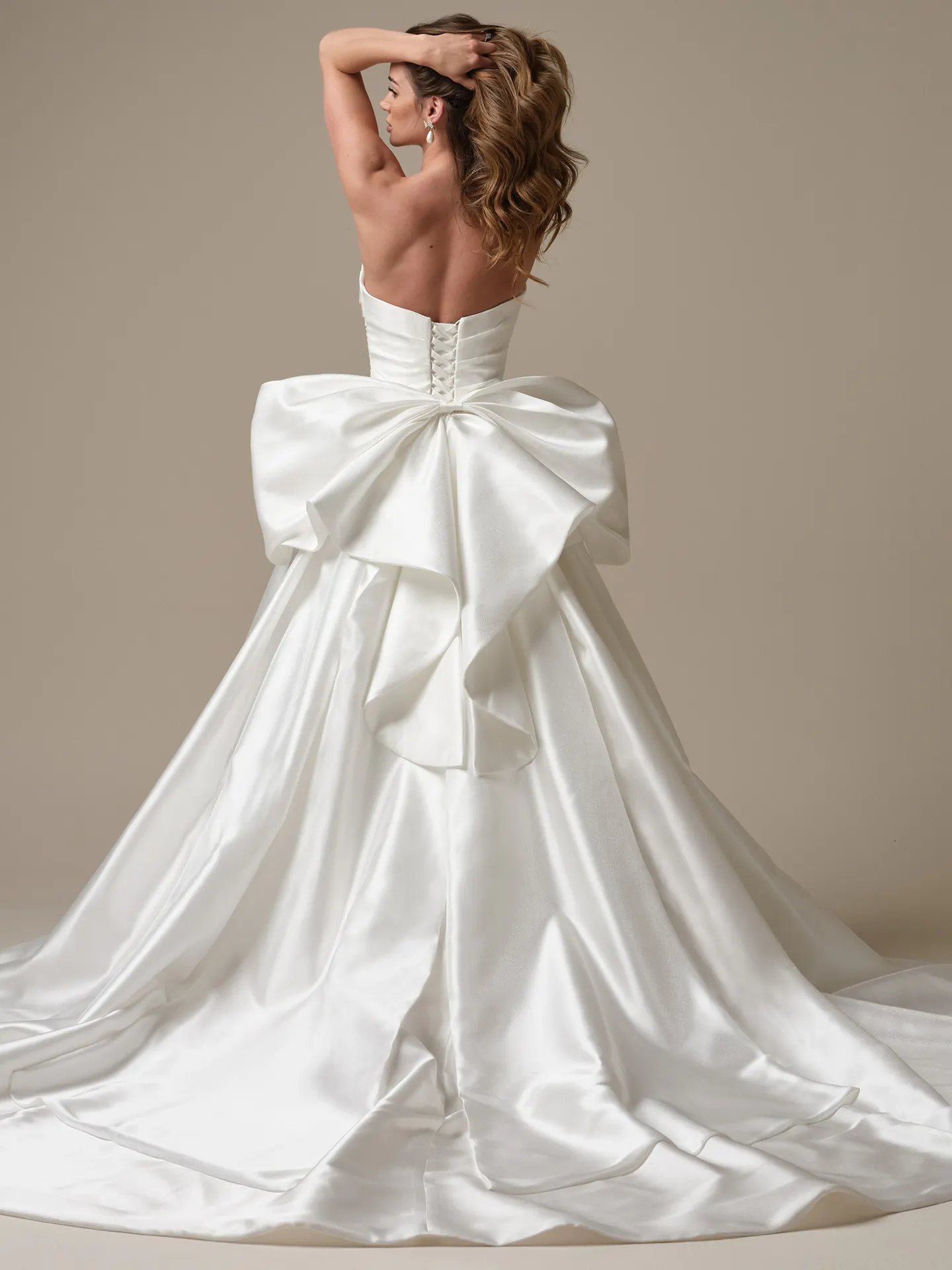 Maggie Sottero Aubrielle satin ball gown back view with large bow detail.