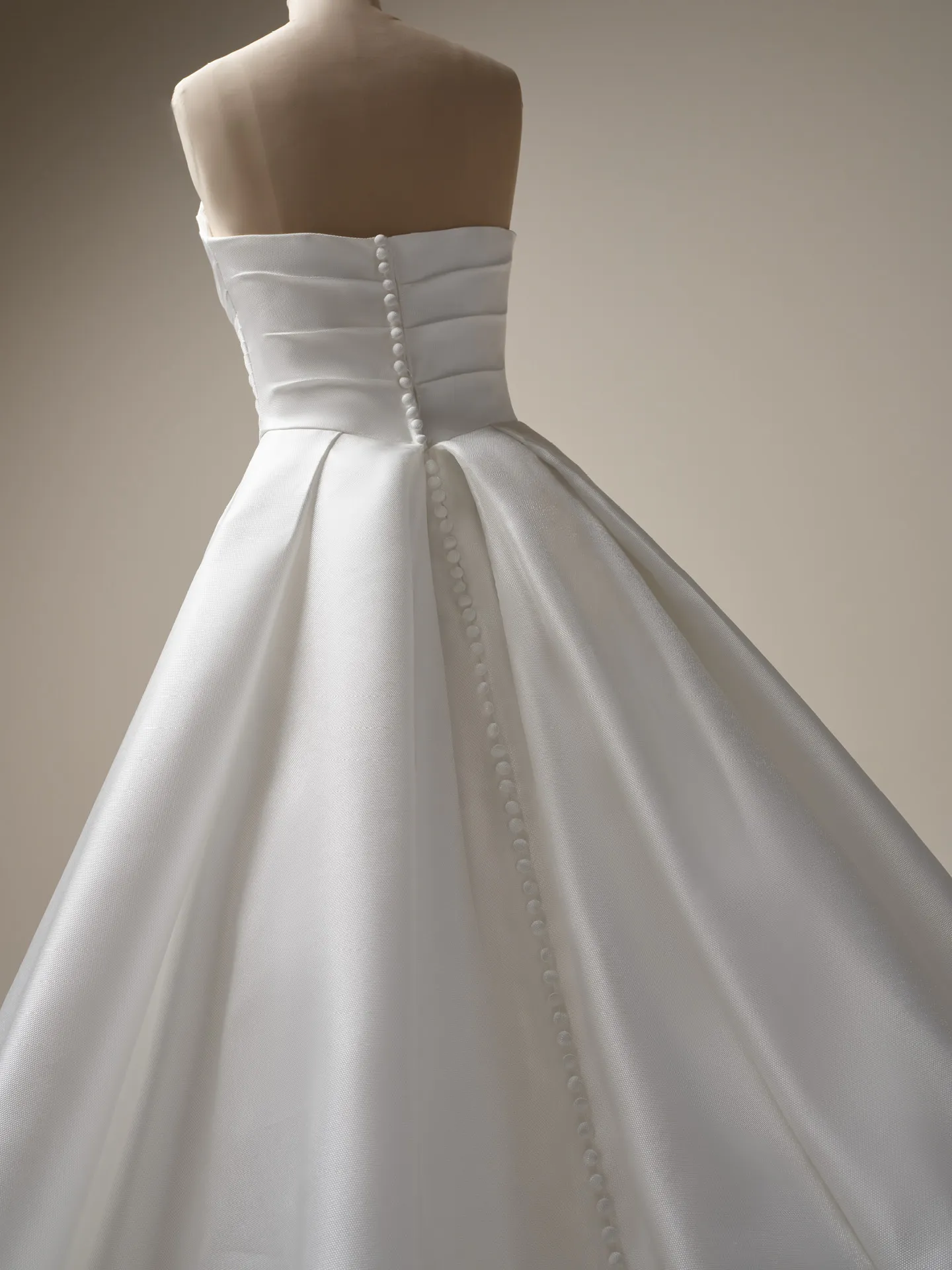 Maggie Sottero Aubrielle back view satin ball gown with button details.