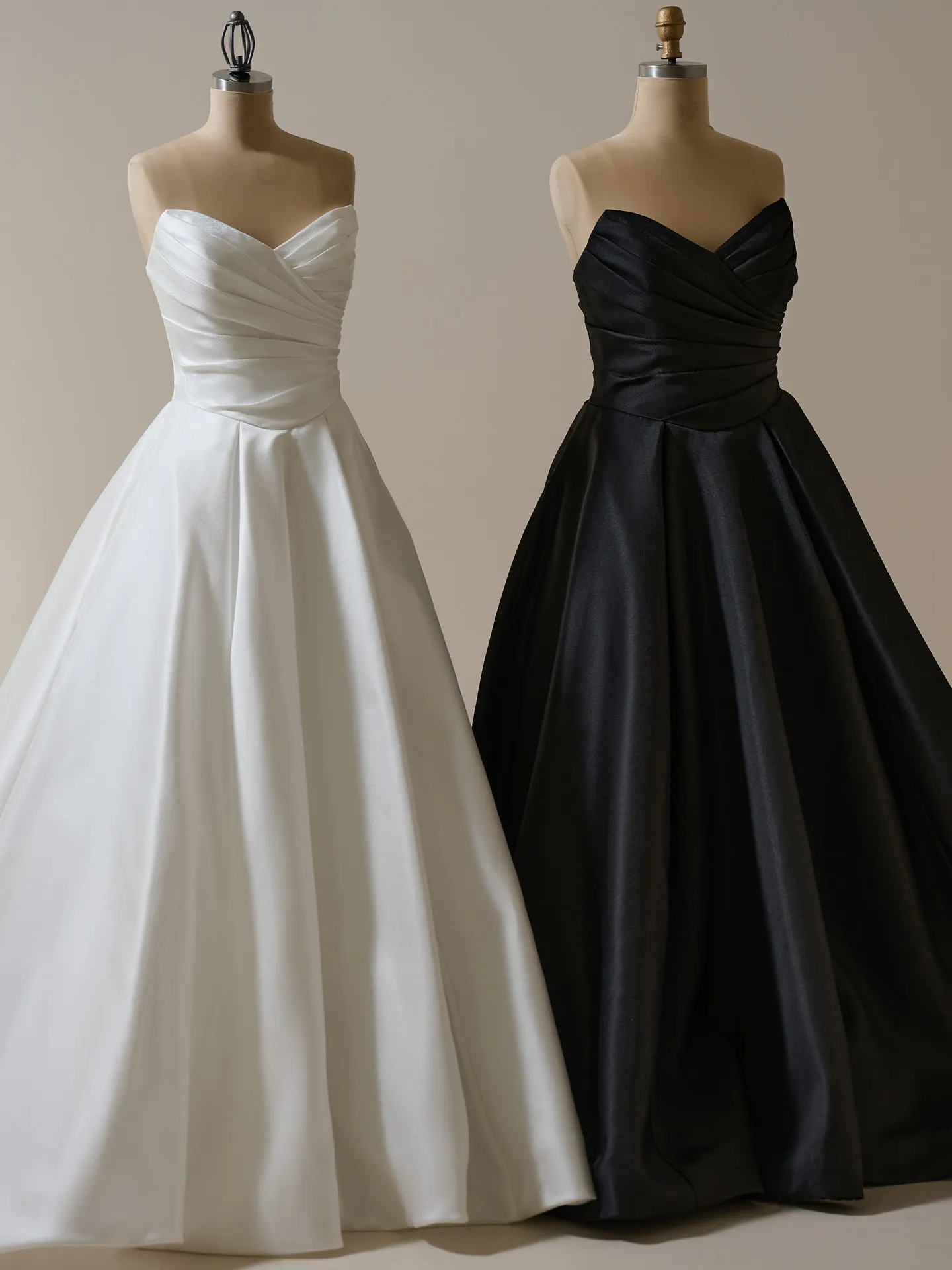Maggie Sottero Aubrielle ball gown front view in white and black on mannequins.