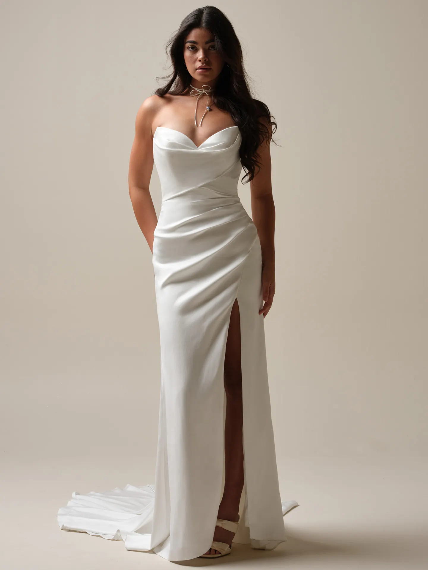 Maggie Sottero Camille satin sheath wedding dress front view with strapless neckline and slit.