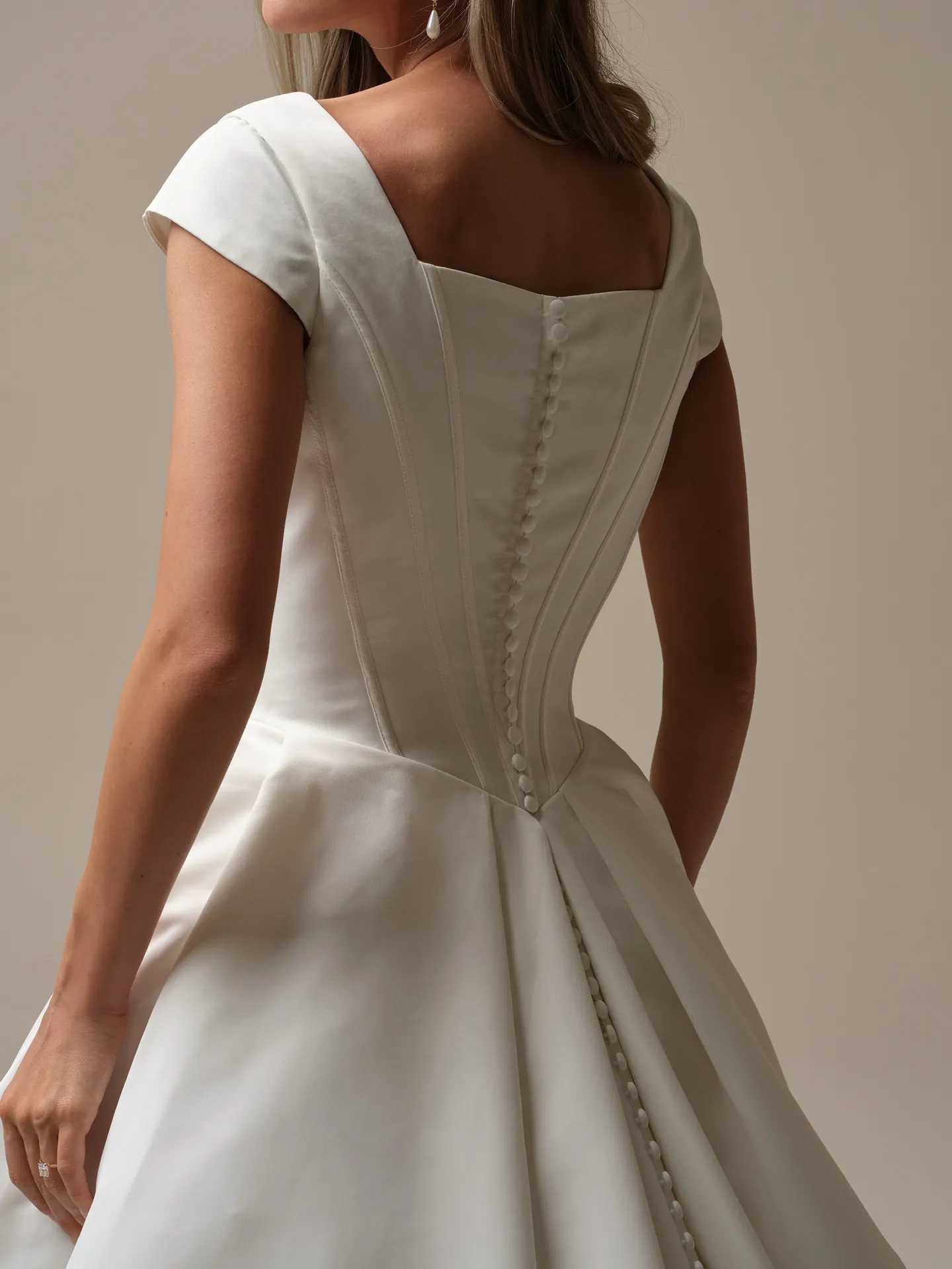 Maggie Sottero Derrick Leigh back view of modest ball gown dress with buttons