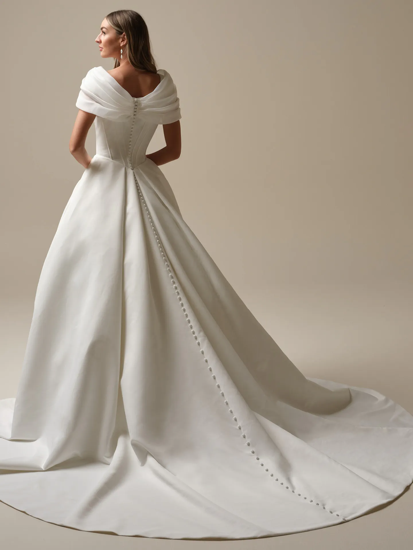 Derrick Leigh back view, ball gown with buttons and off-shoulder design by Maggie Sottero.
