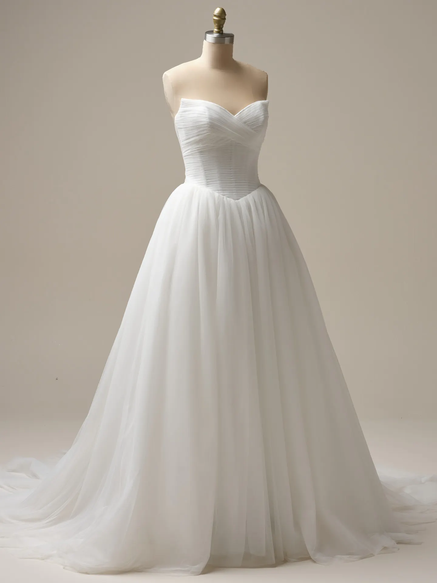 Maggie Sottero Evan ball gown front view with pleated bodice on mannequin.