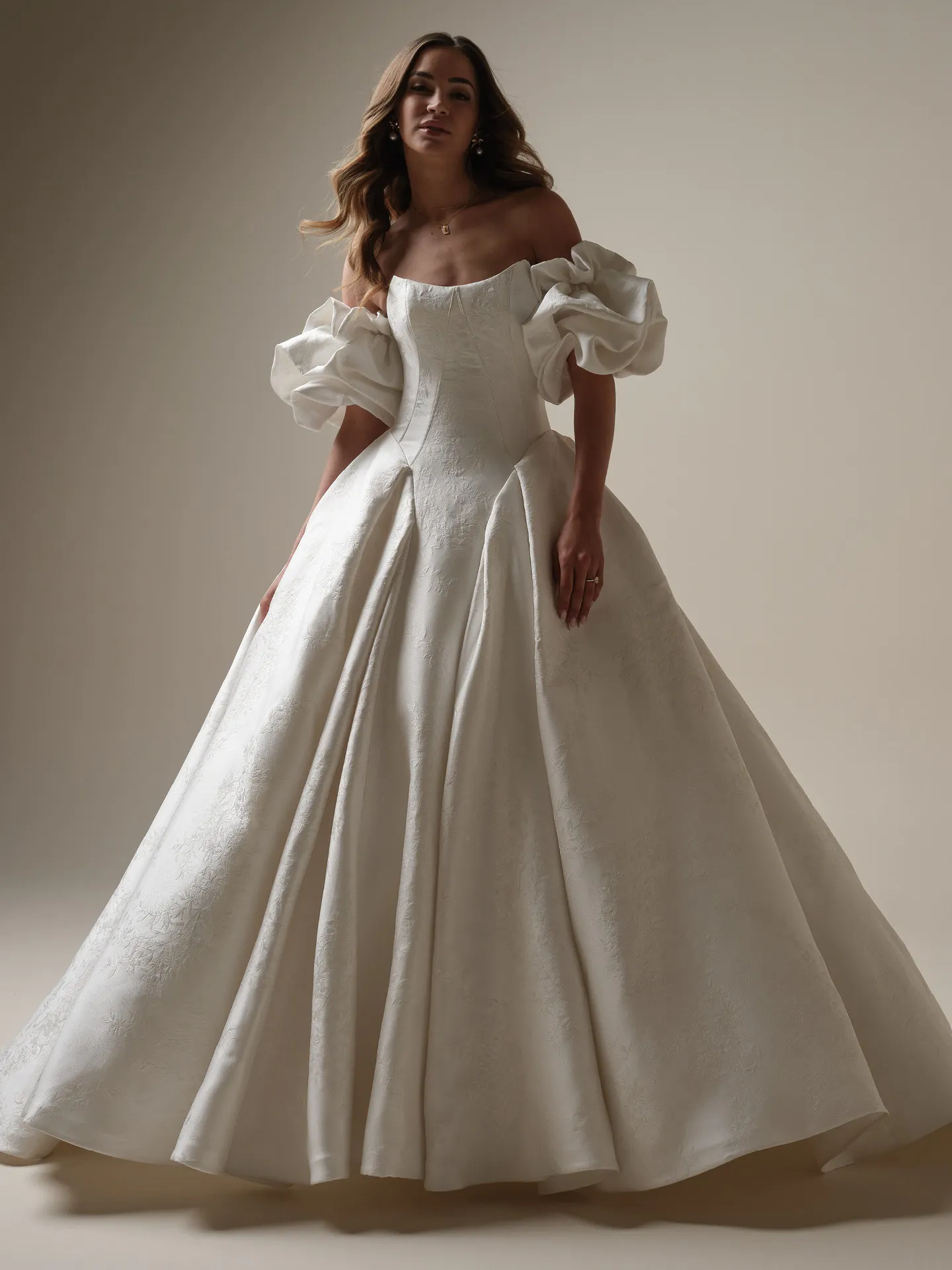 Maggie Sottero Fortune Marie front view with puff armbands and floral jacquard pattern.