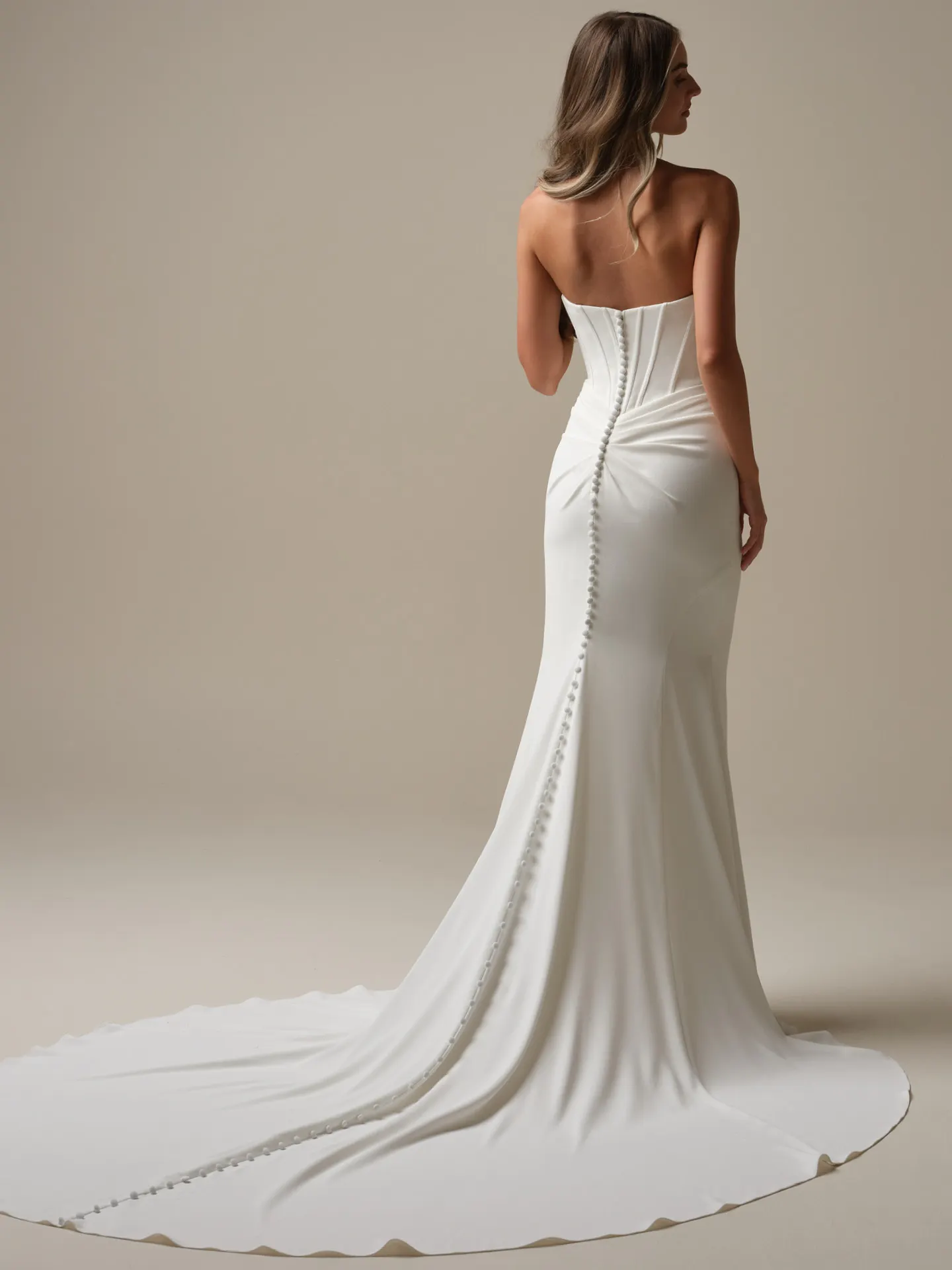 Maggie Sottero Jace back view crepe sheath wedding dress with button detail.