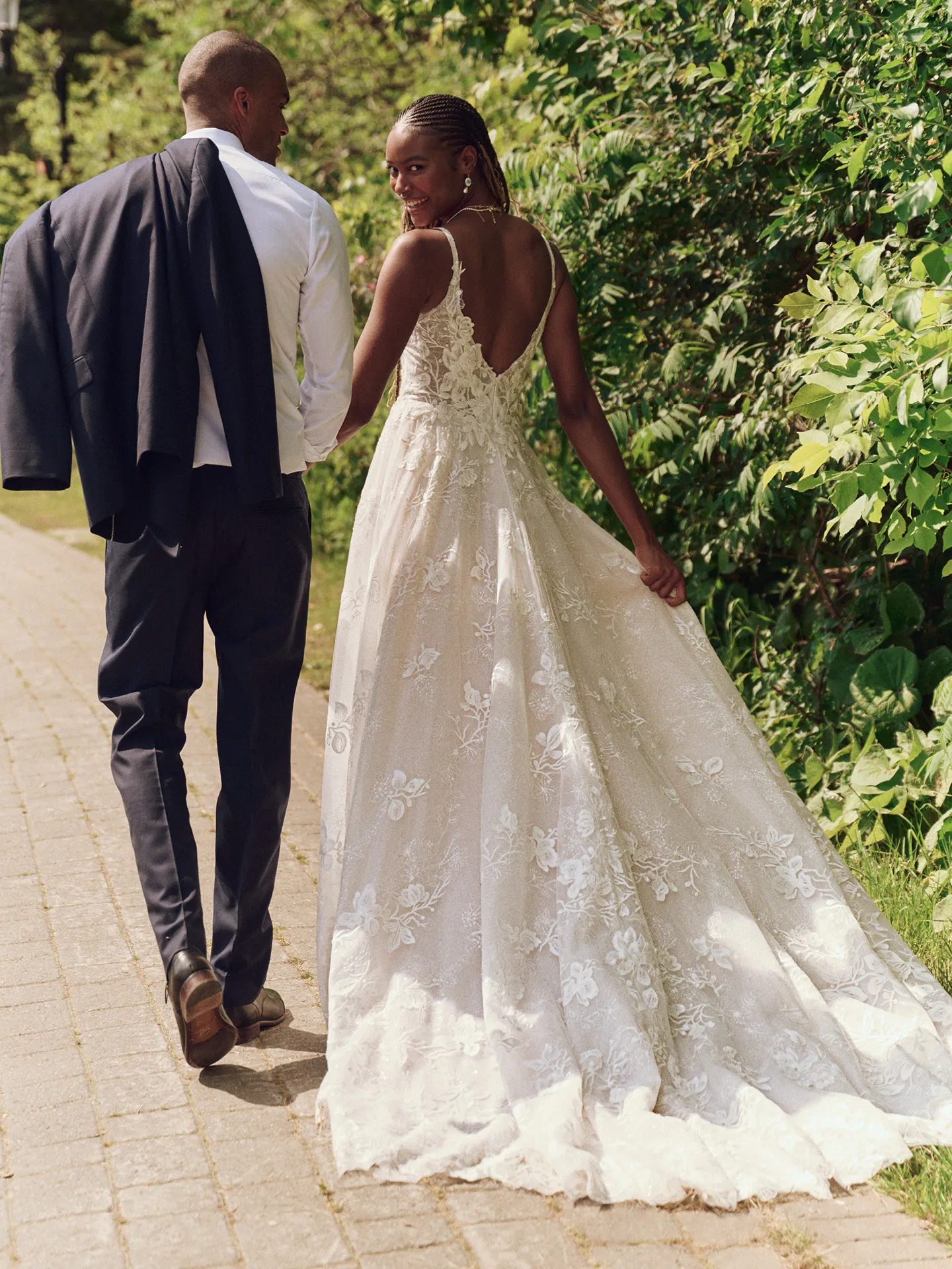 Maggie Sottero Jerrica back view, beaded floral A-line wedding dress in garden setting.