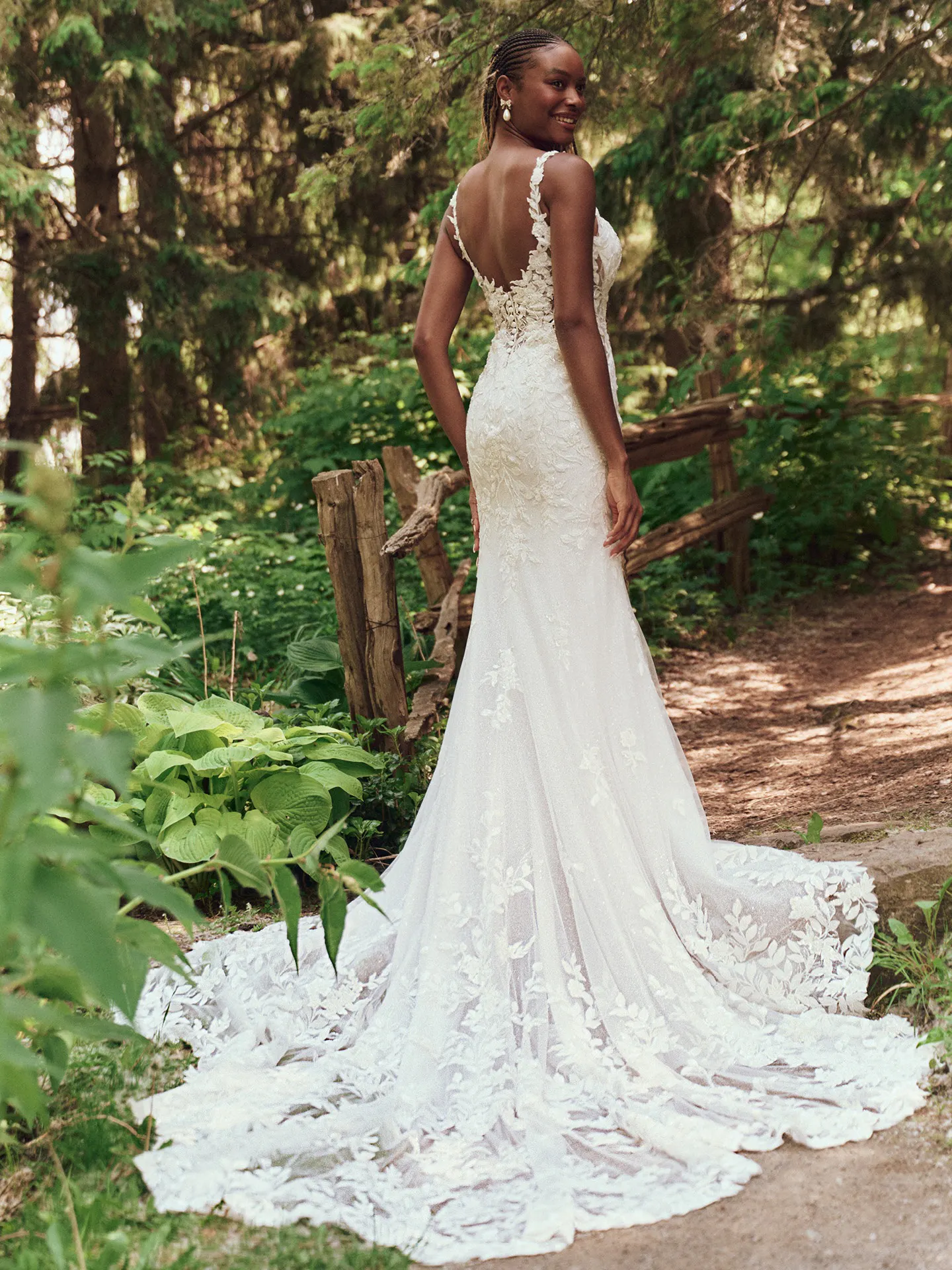 Maggie Sottero Keegan back view, glittering mermaid wedding dress in forest setting.