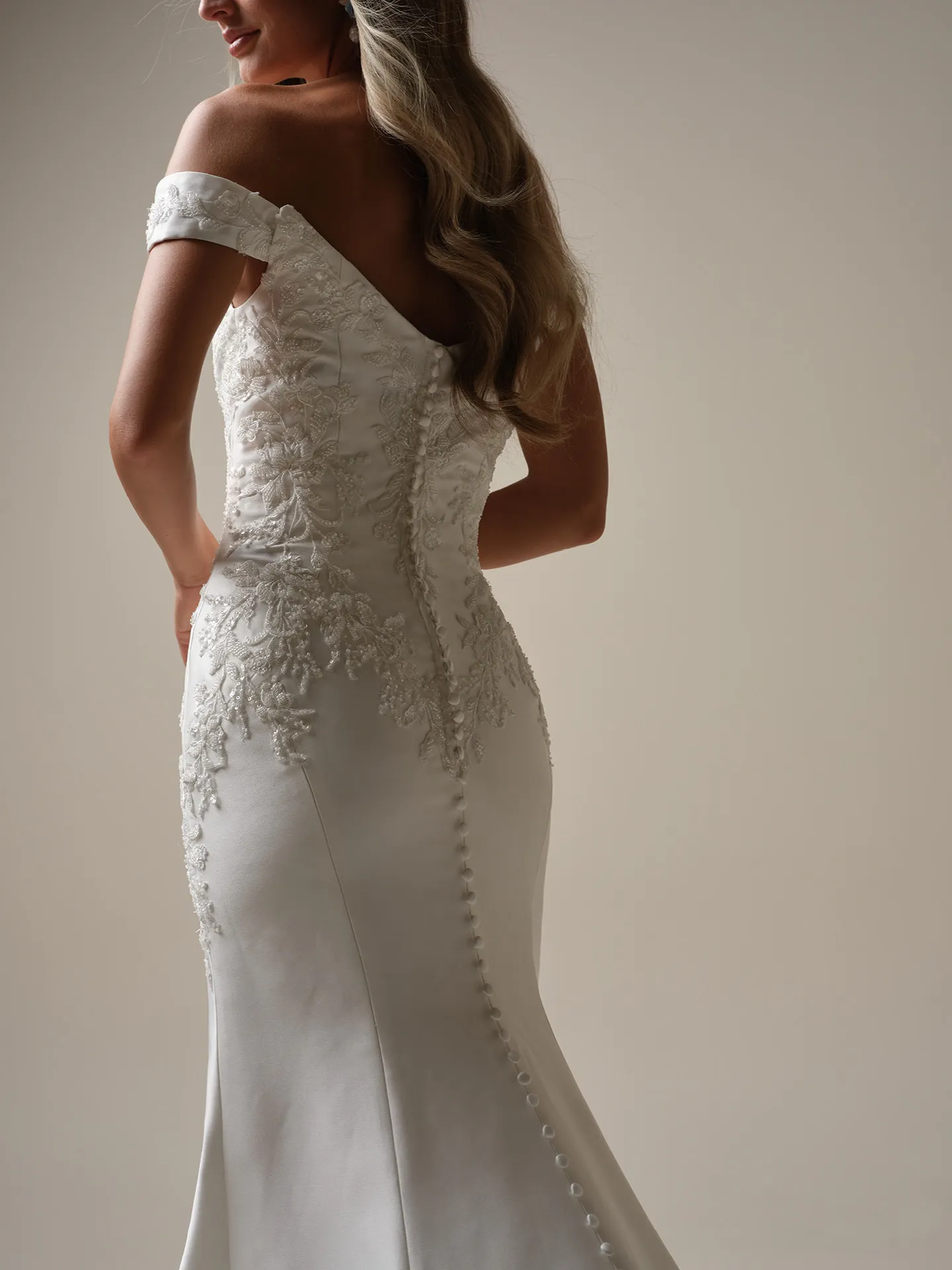Maggie Sottero Loreen back view fit-and-flare wedding dress with lace and button detail.