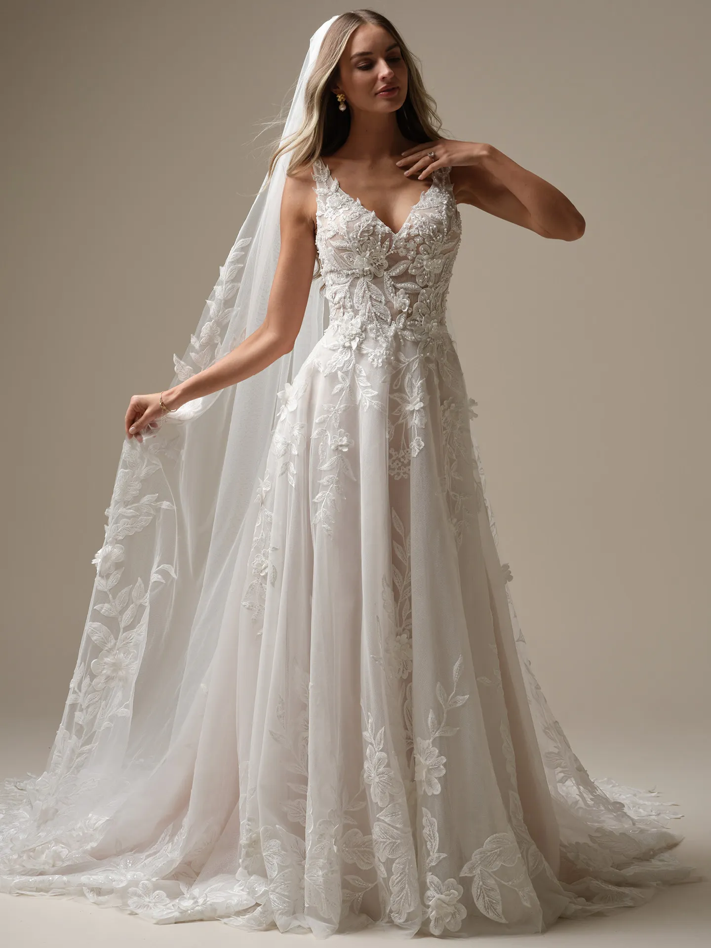 Maggie Sottero floral embellished gown with Magnolia cathedral veil front view.
