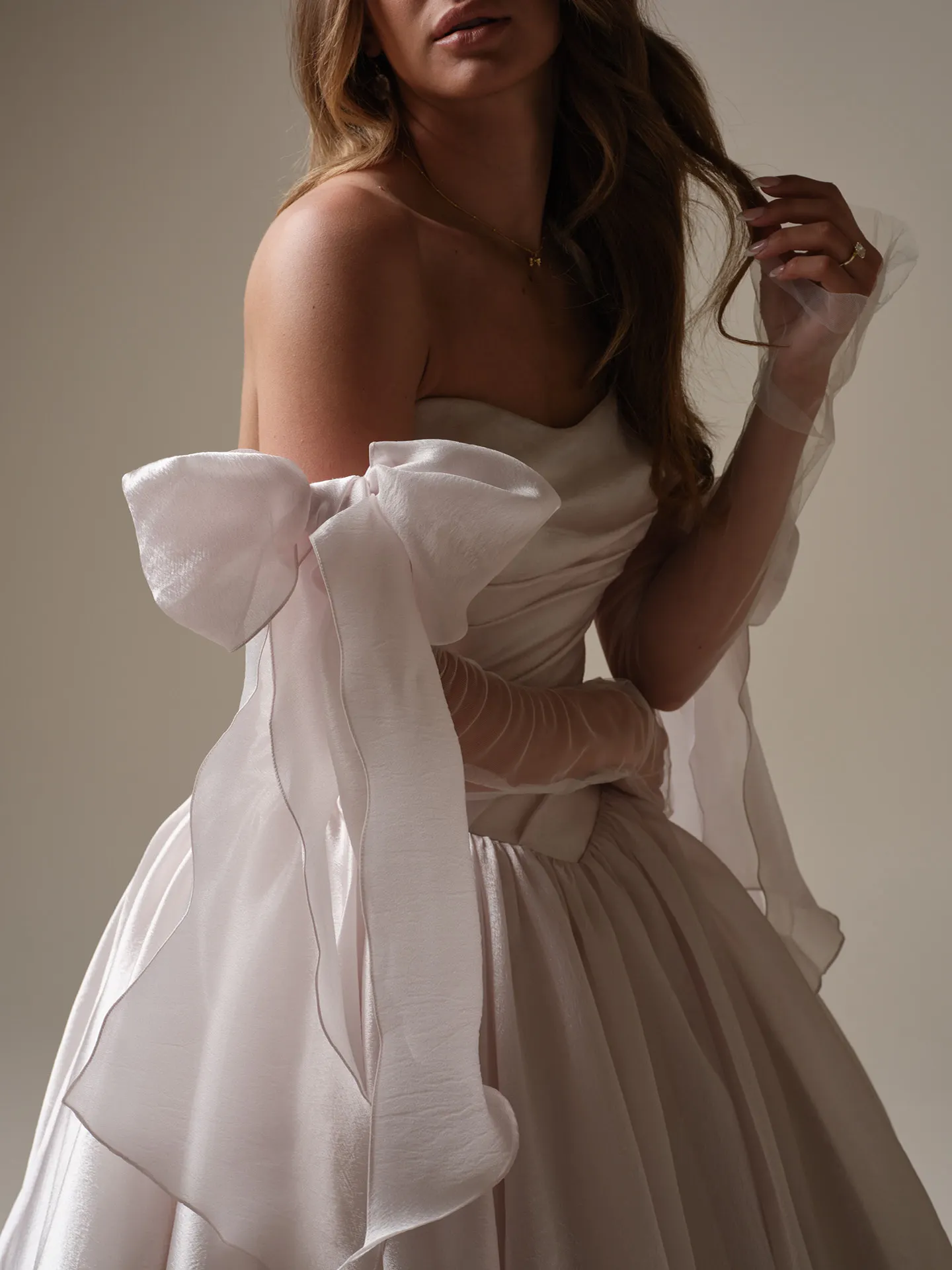 Maggie Sottero Paris side view with large bow and asymmetrical waist accents