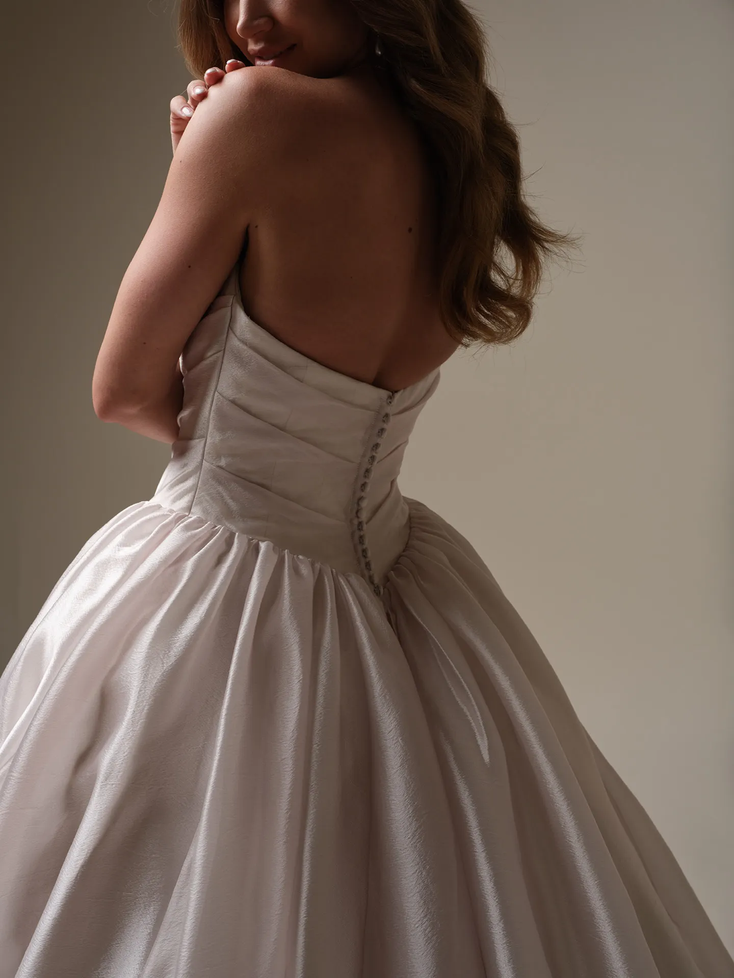 Maggie Sottero Paris back view, asymmetrical basque waist bridal dress