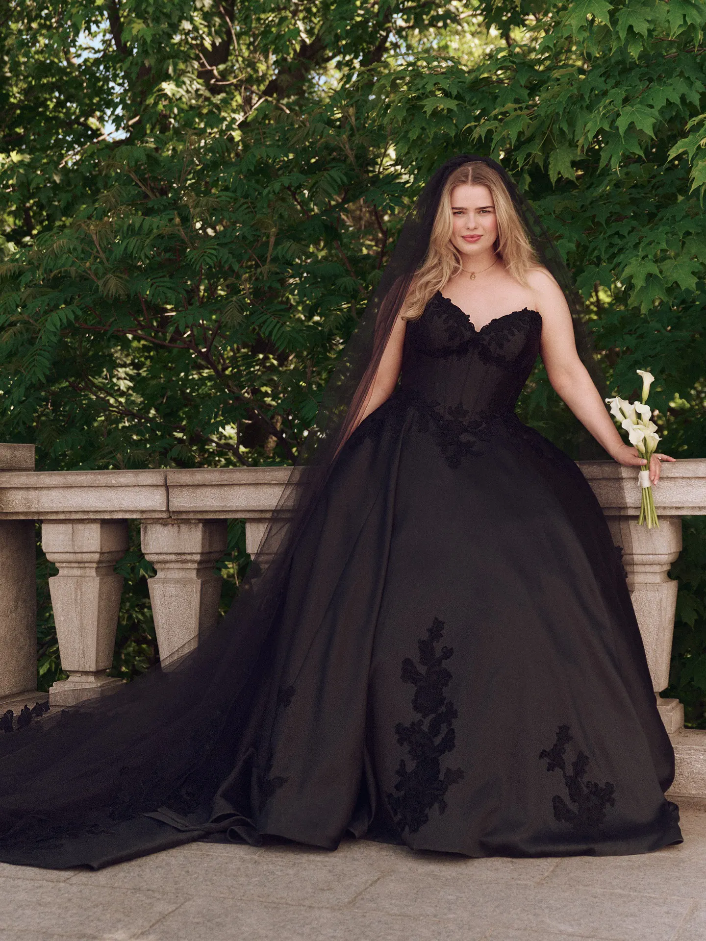 Serafina satin ball gown front view with floral lace, outdoor setting.