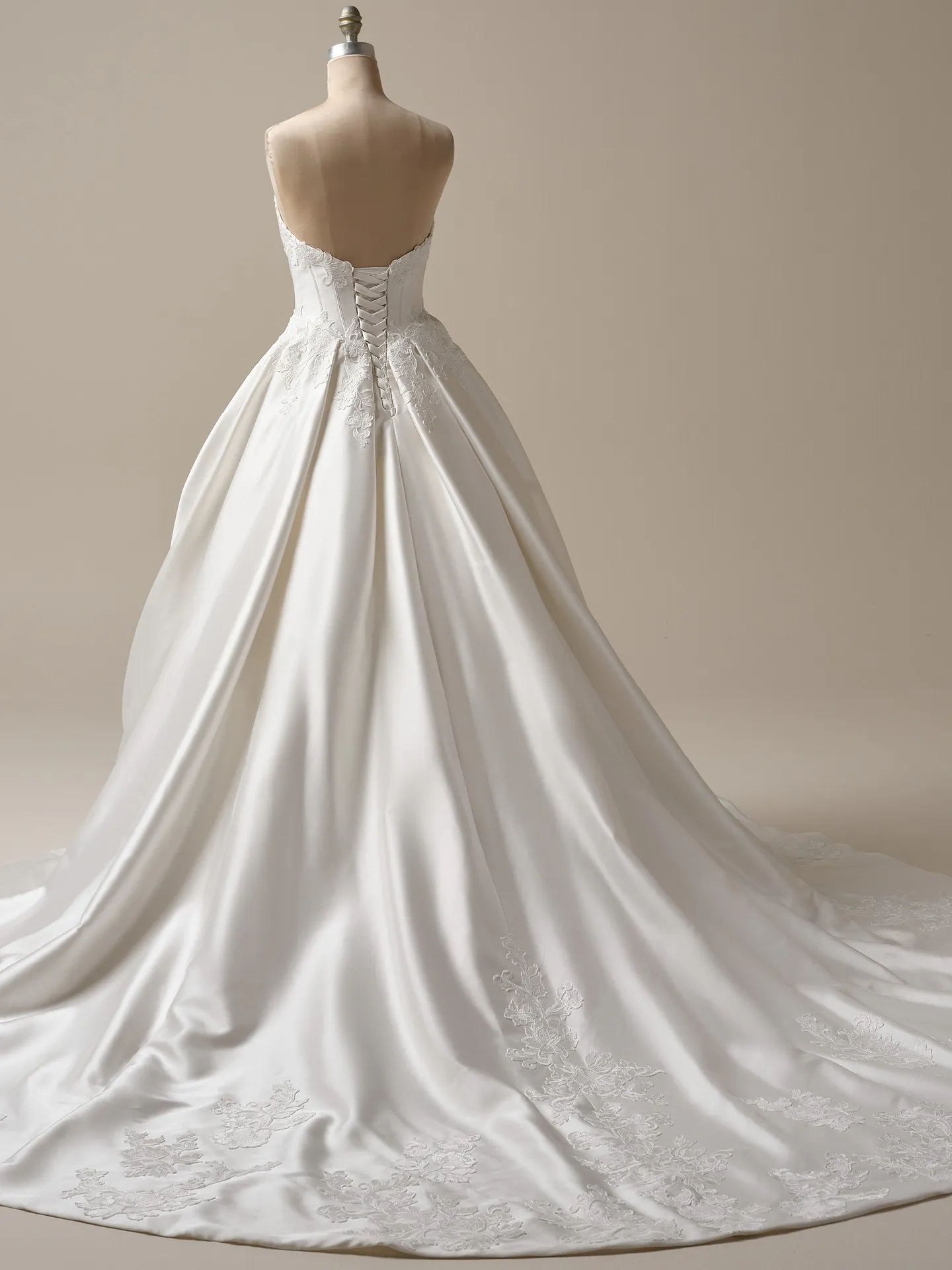 Maggie Sottero Serafina back view satin ball gown with basque waist and lace detail.