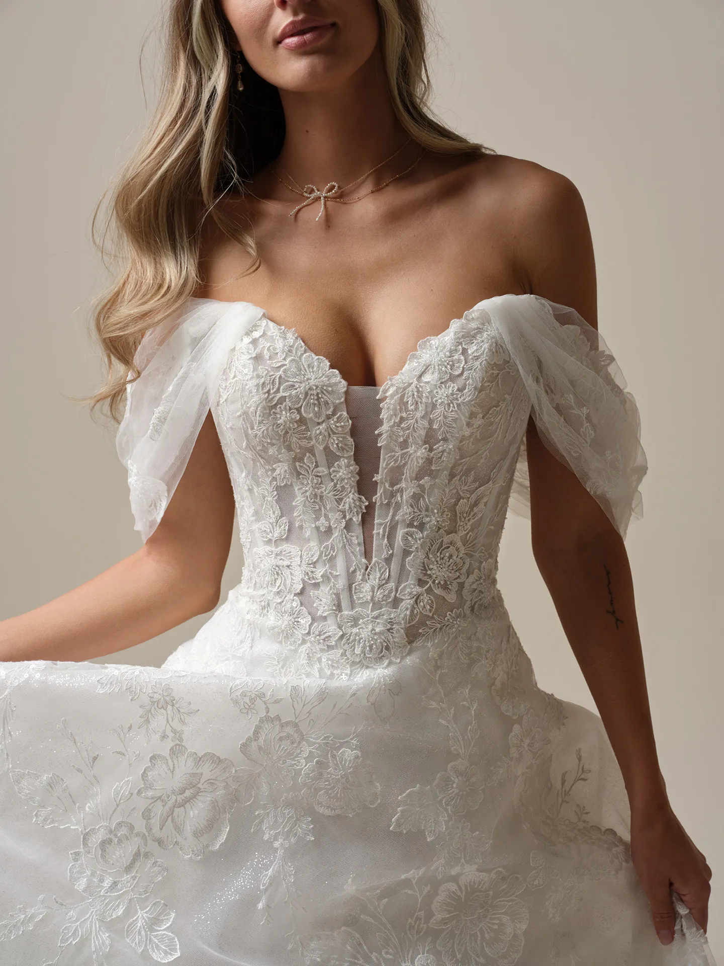 Maggie Sottero Skylar front view lace dress with detachable illusion cap-sleeves.