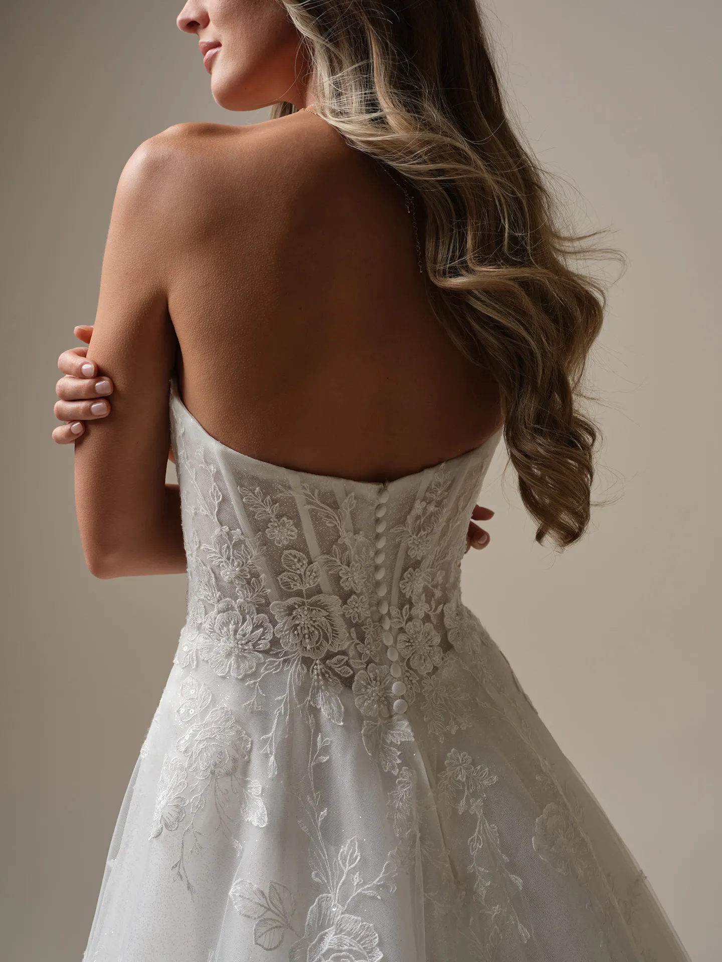 Maggie Sottero Skylar back view lace A-line bridal gown with button detail.
