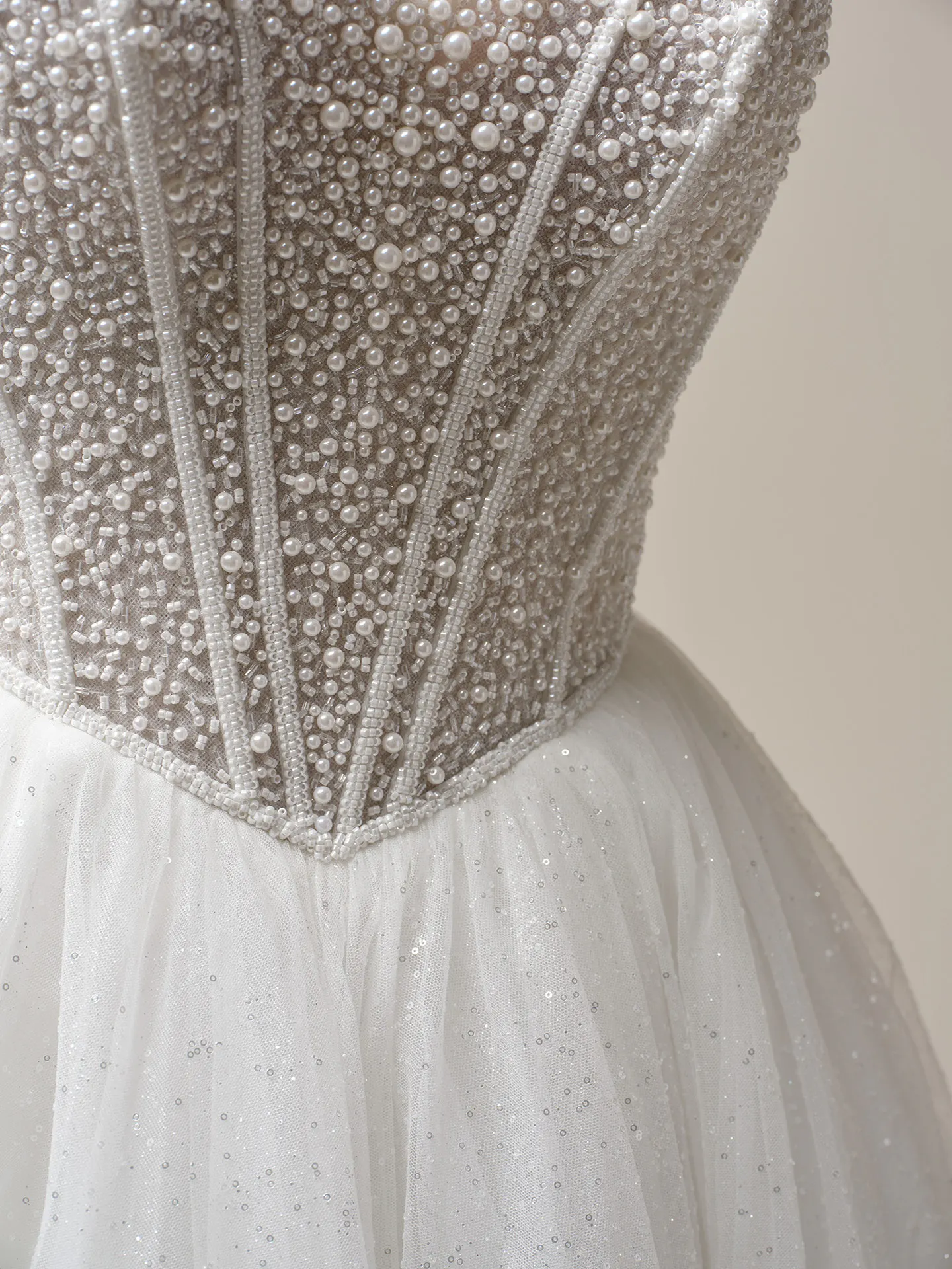 Maggie Sottero Tina Lane close-up of pearl and sequin bodice detail.