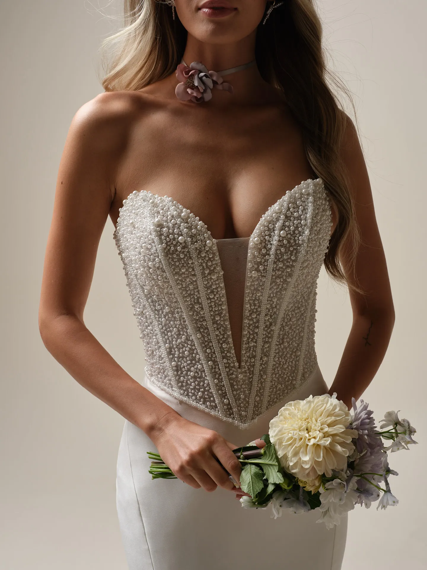 Maggie Sottero Tina Marie front view: pearl-embellished strapless bustier with mermaid silhouette.