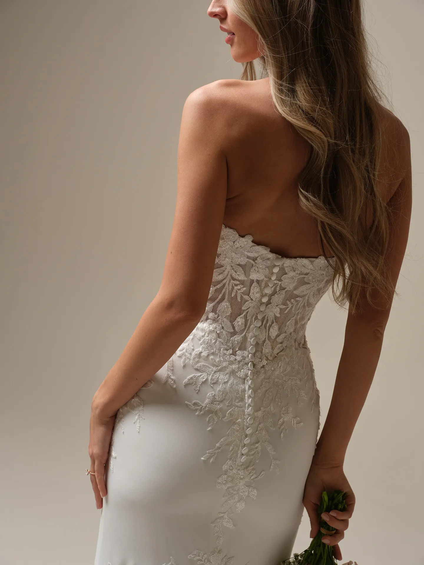 Maggie Sottero Yara back view lace illusion sheath wedding dress.