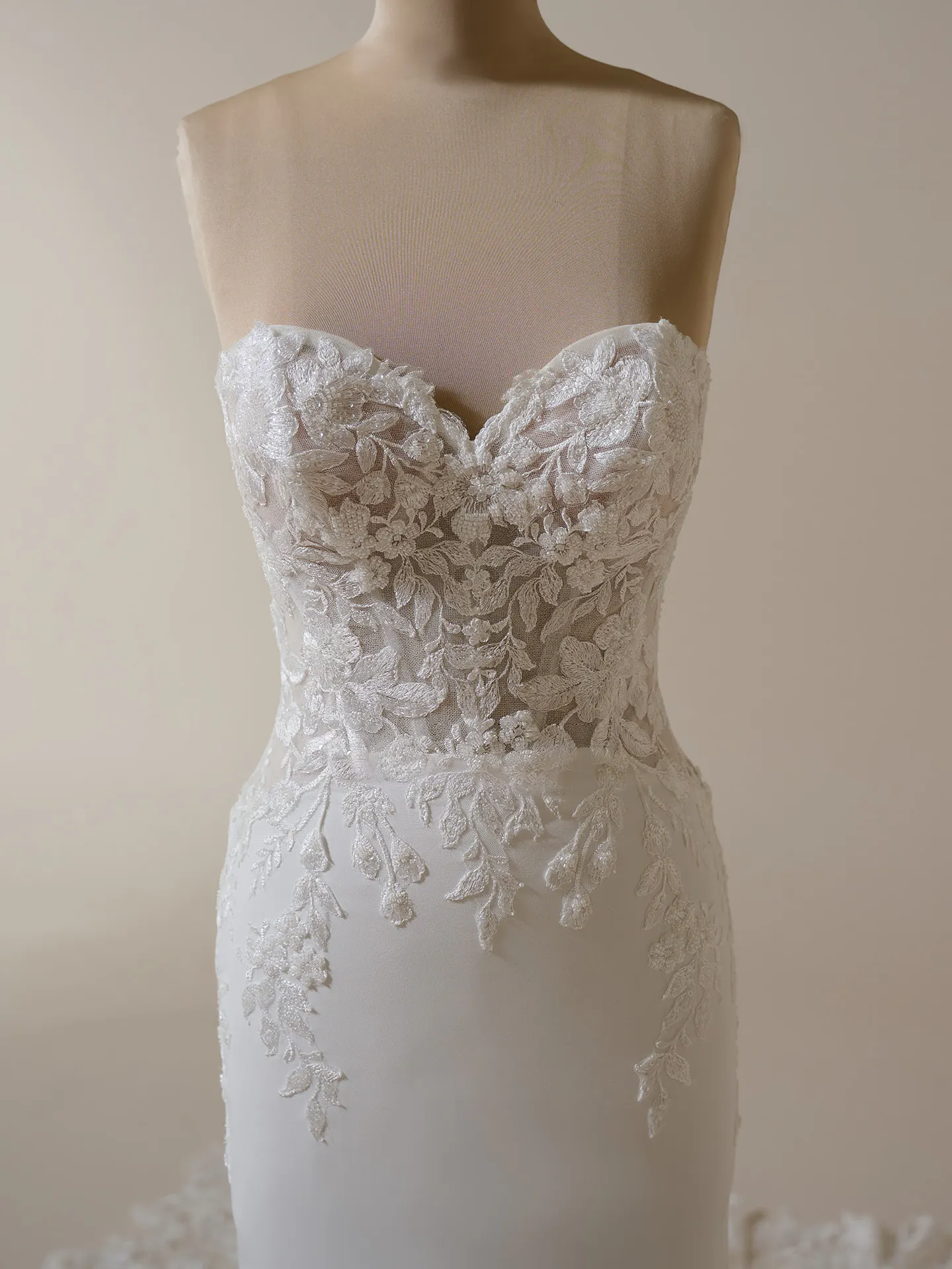 Maggie Sottero Yara front view, plunging illusion crepe sheath with lace details