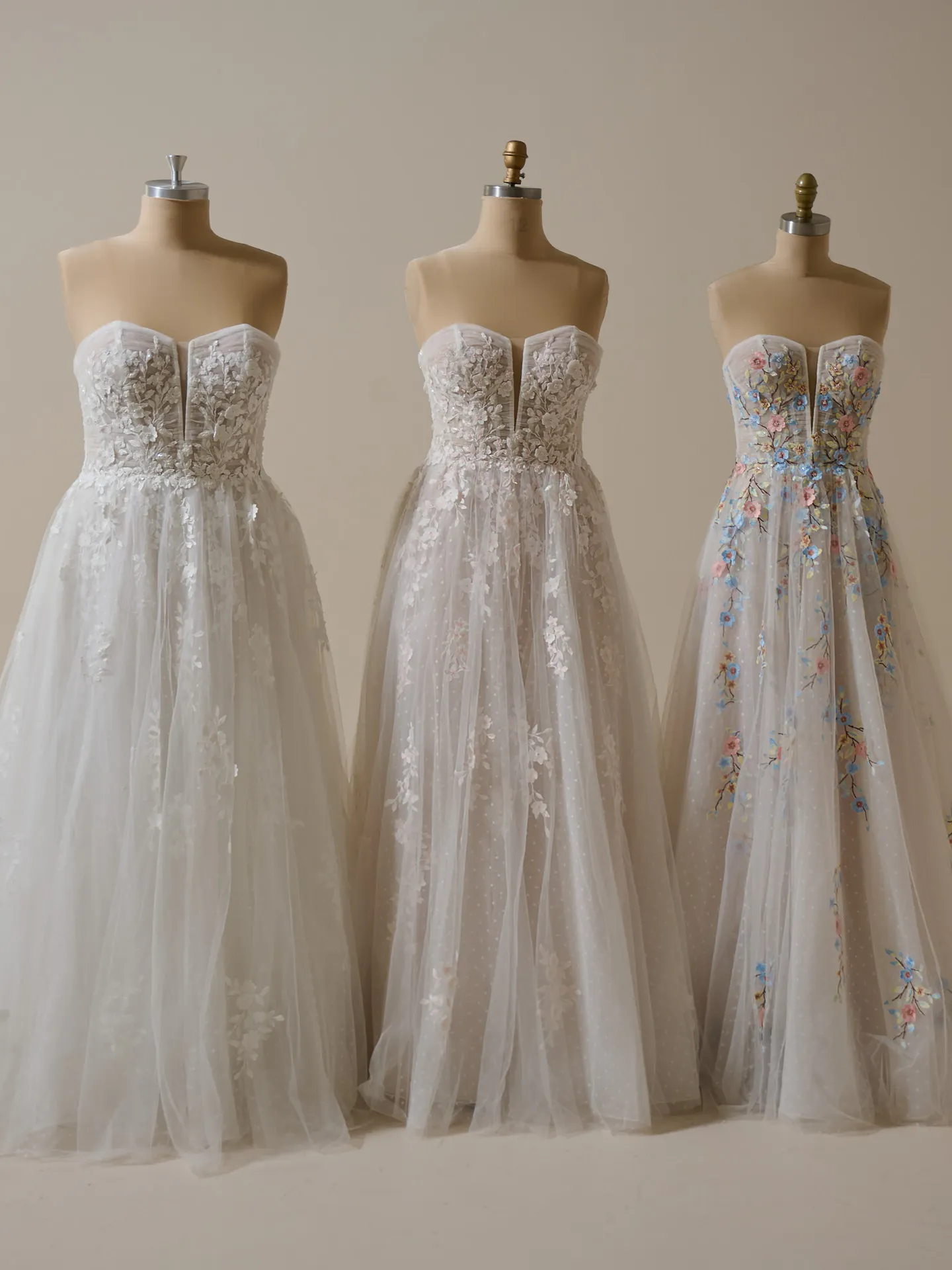 Maggie Sottero Zephyrine floral A-line gowns on mannequins, front view.