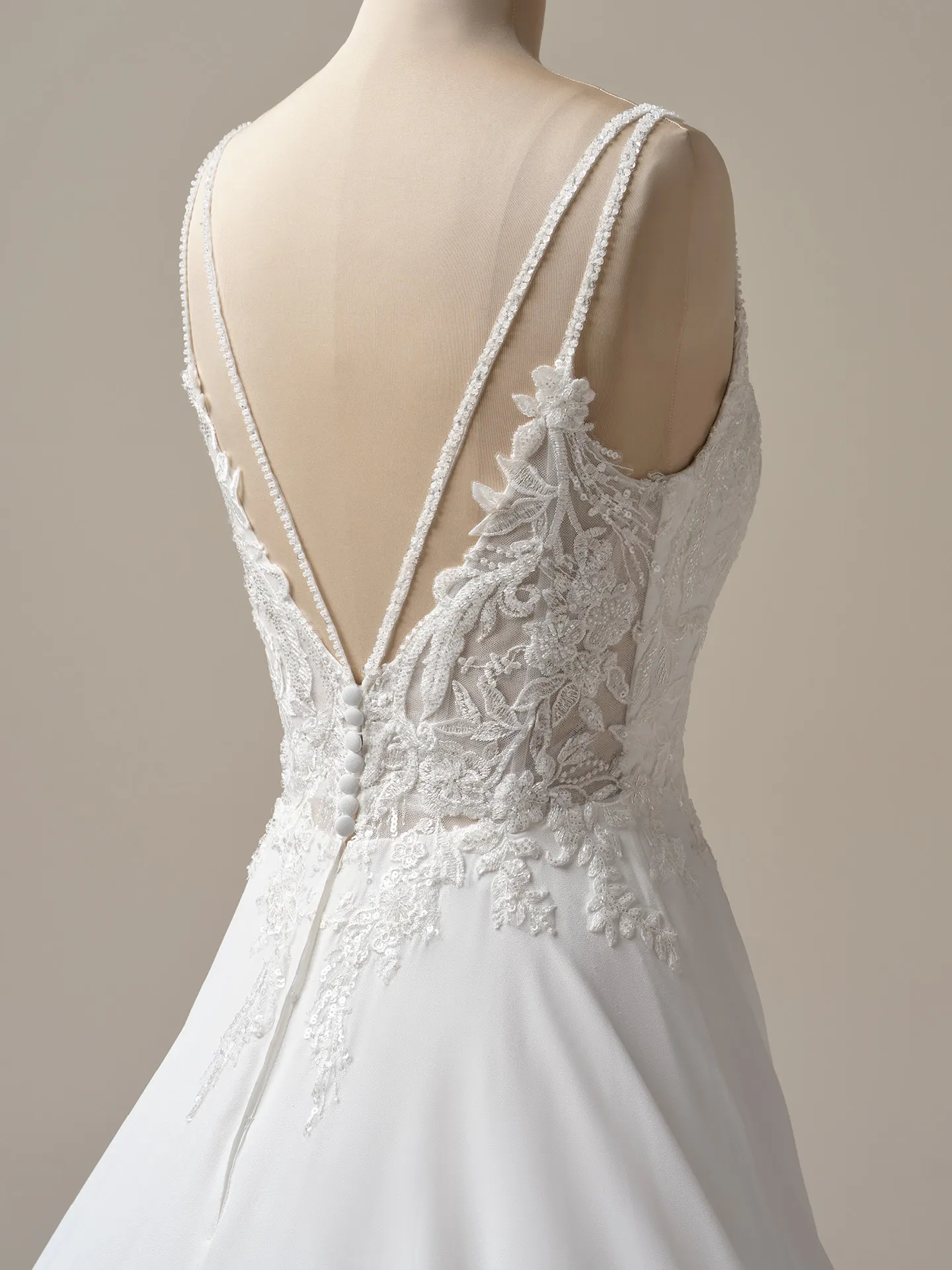 Maggie Sottero Avery back view, chiffon A-line wedding gown with lace detailing.