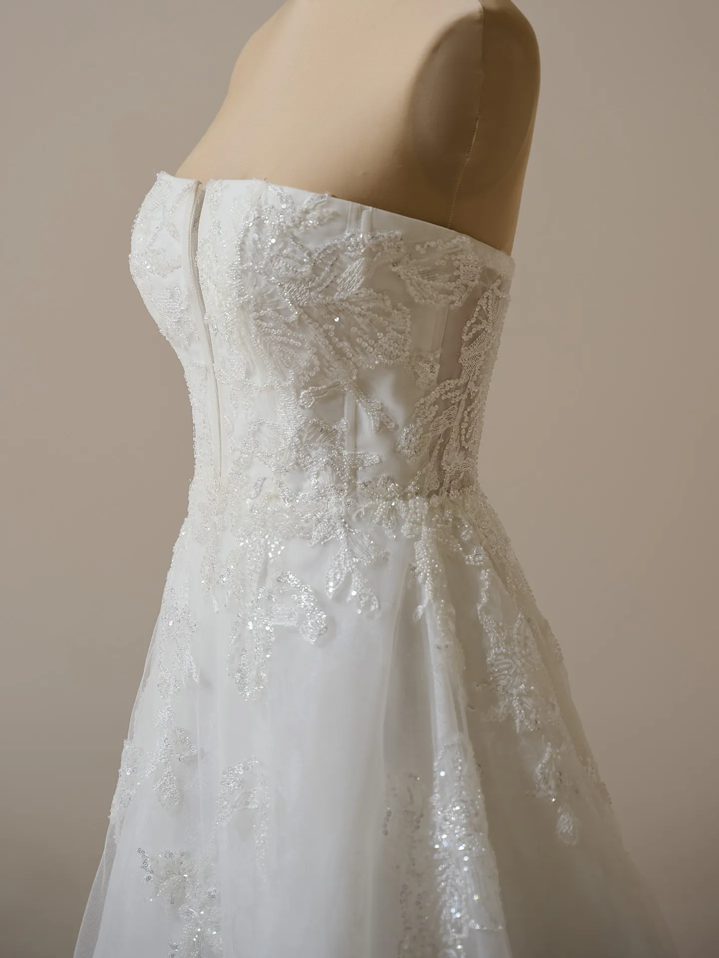 Maggie Sottero Billie side view; floral organza A-line gown with textured lace detailing.