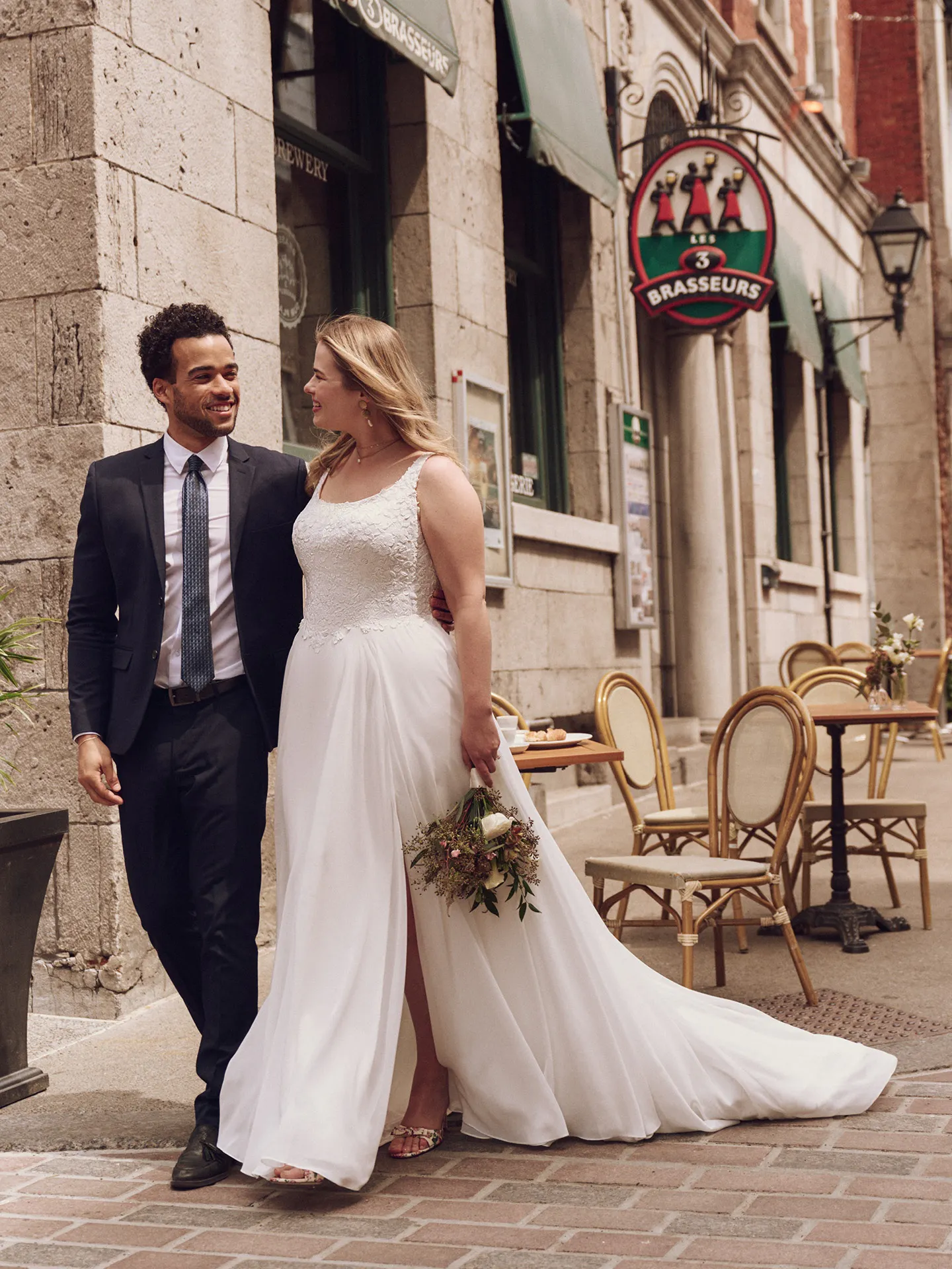 Maggie Sottero Cory A-line dress in street setting, side slit visible
