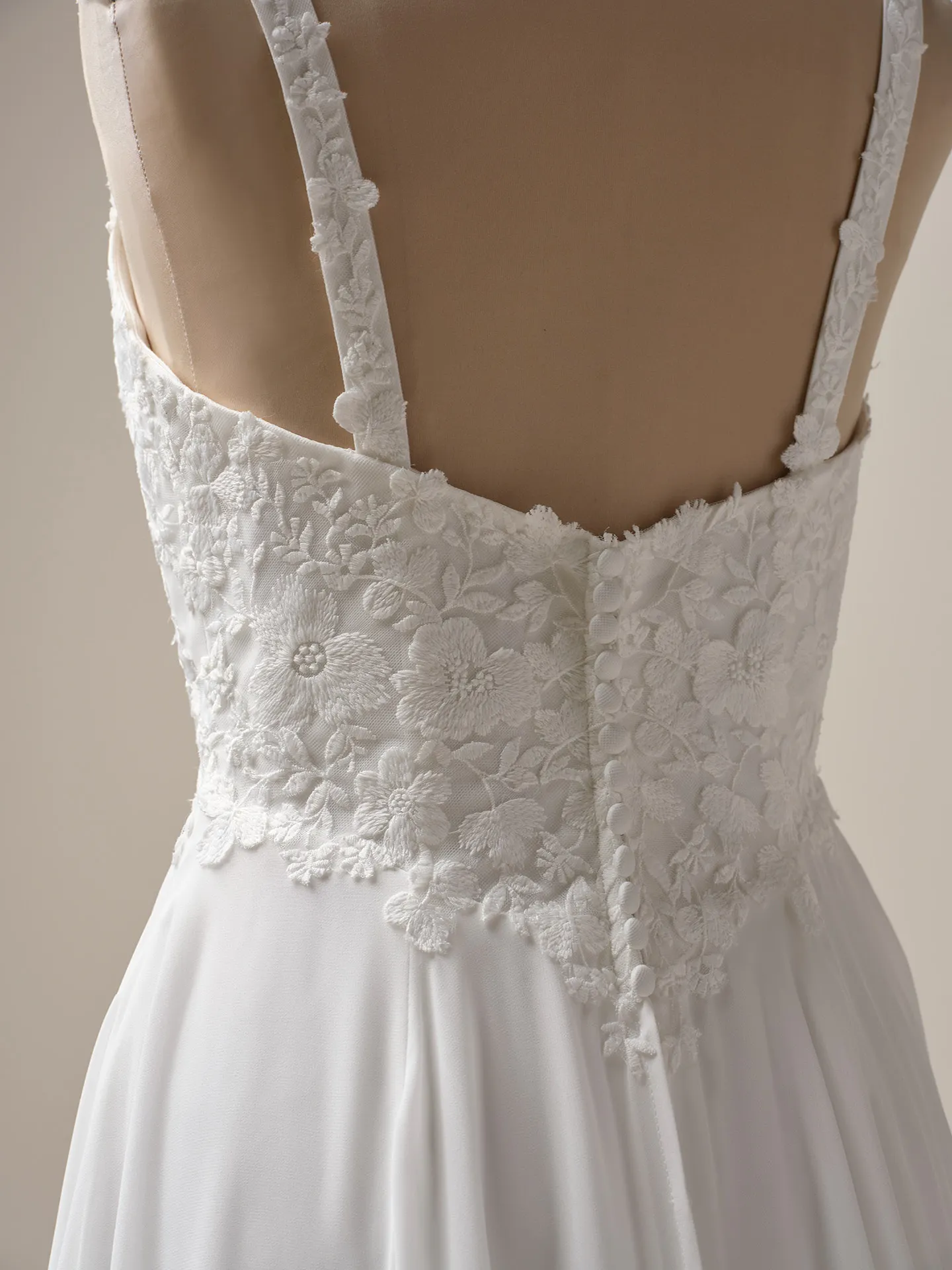 Maggie Sottero Cory back view, floral lace bodice, chiffon A-line skirt.