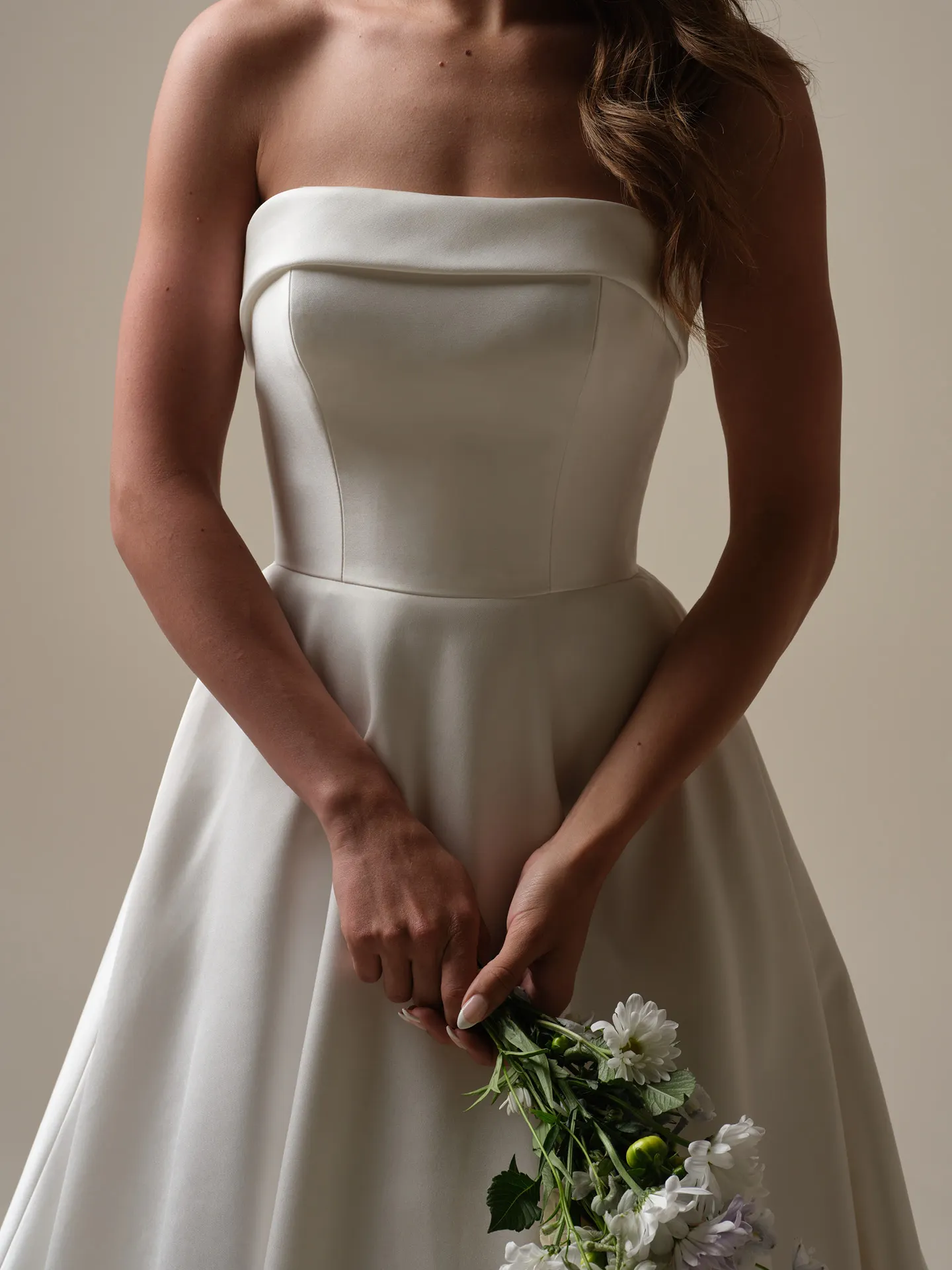 Rebecca Ingram Elizabeth Marie satin A-line front view with floral bouquet