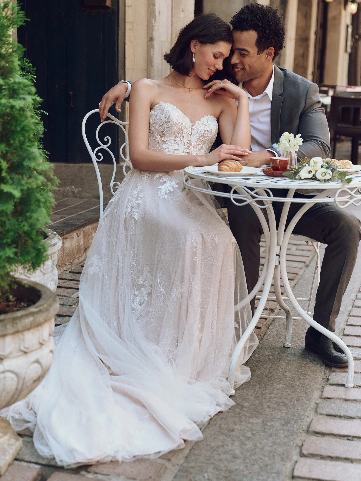 Maggie Sottero Jalissa floral A-line gown front view sitting at cafe table