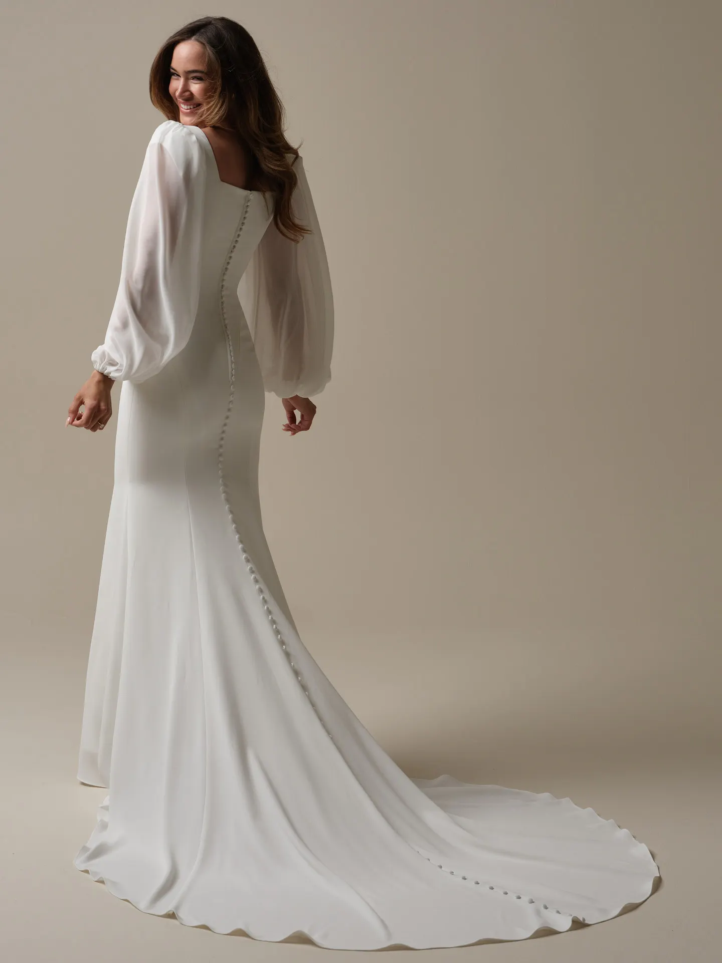 Jorie back view, Maggie Sottero sheath bridal gown with square neckline and long sleeves.