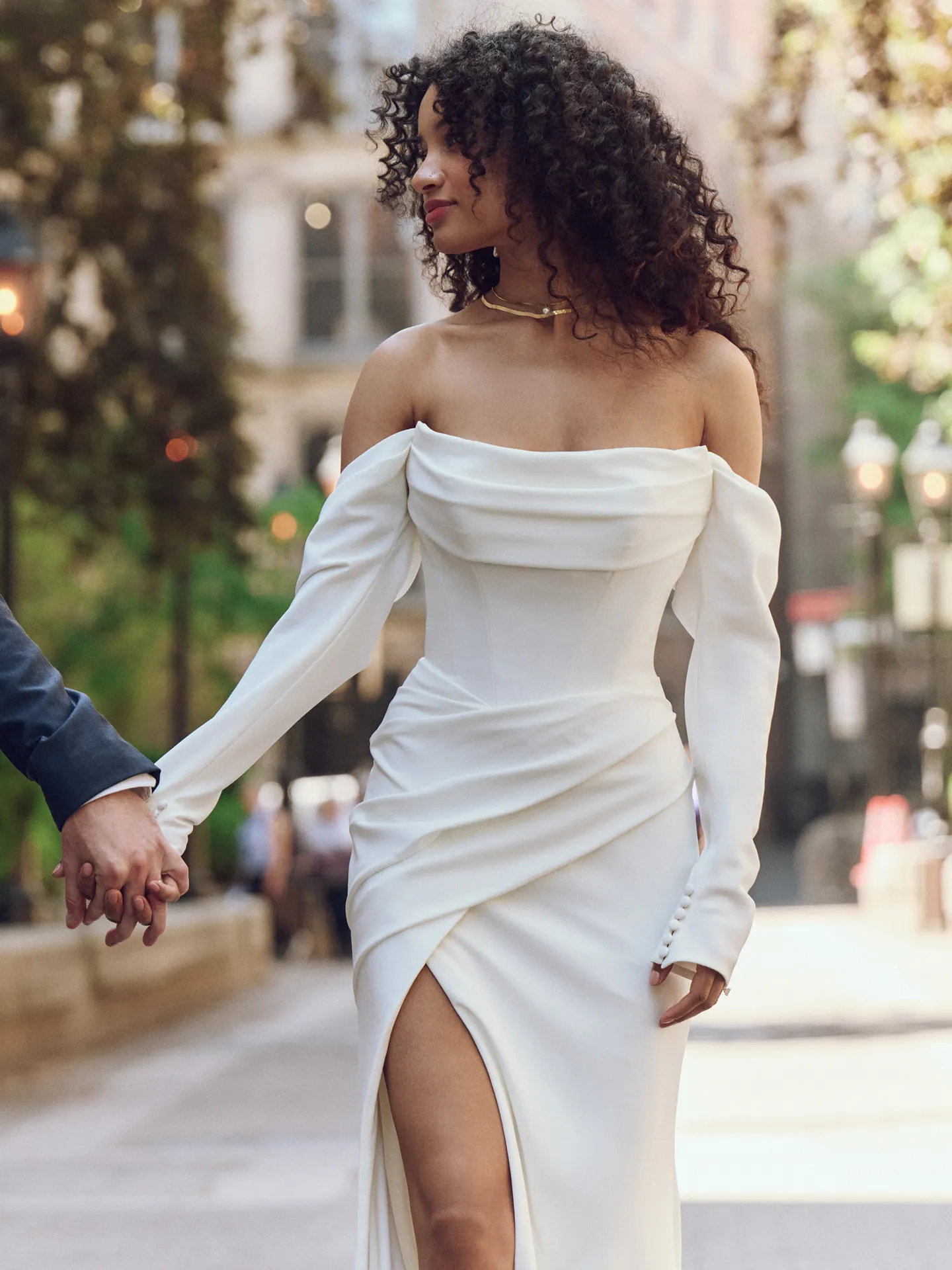 Maggie Sottero Kailani side view, crepe cowl wedding dress, basque waist, city scene