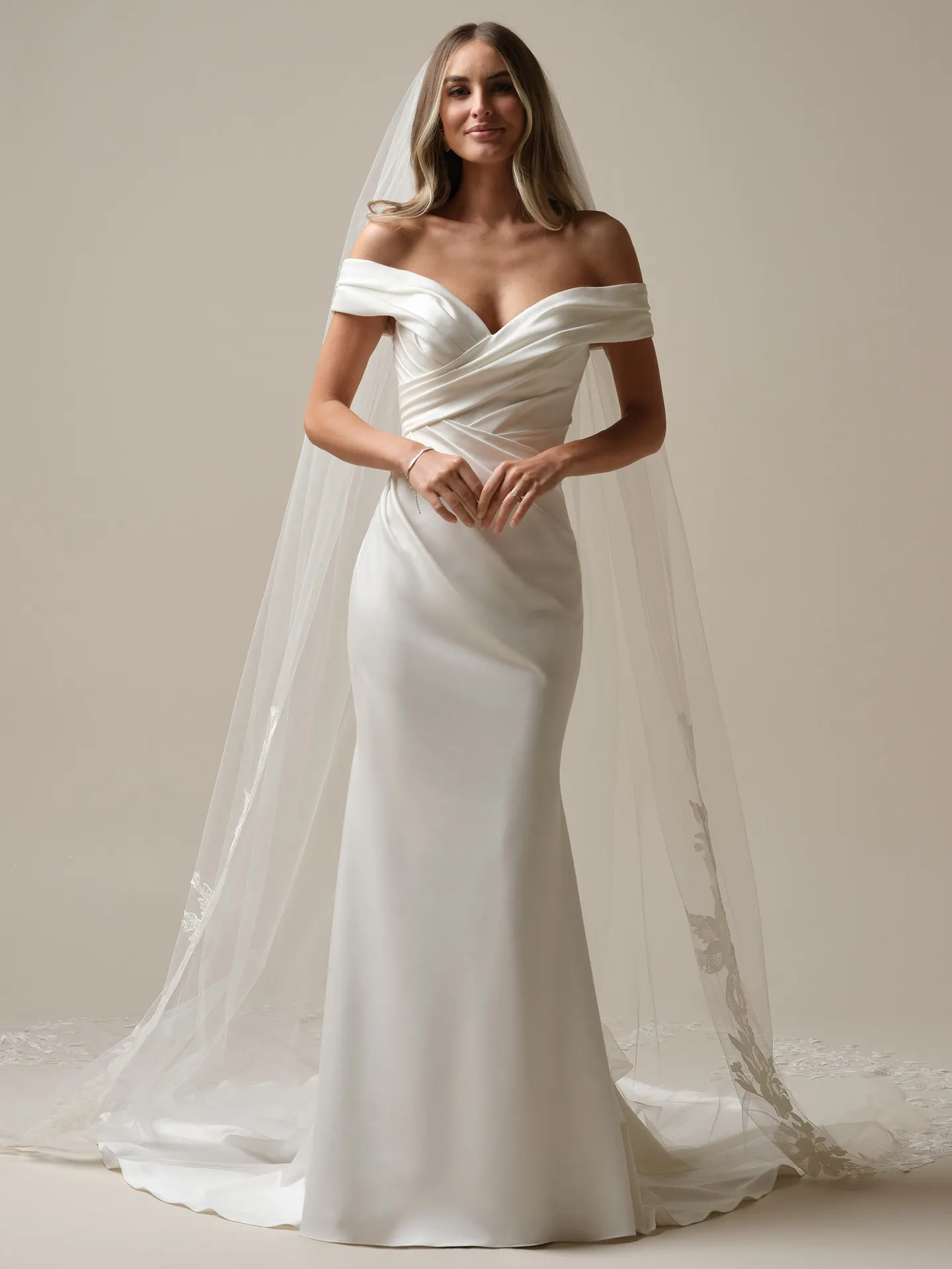Maggie Sottero Latoya front view satin asymmetrical mermaid bridal dress with veil.