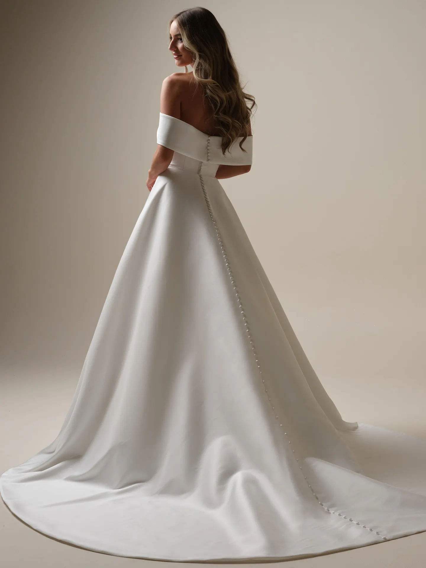 Maggie Sottero Perri A-line back view satin with banded cuffs and button detail.