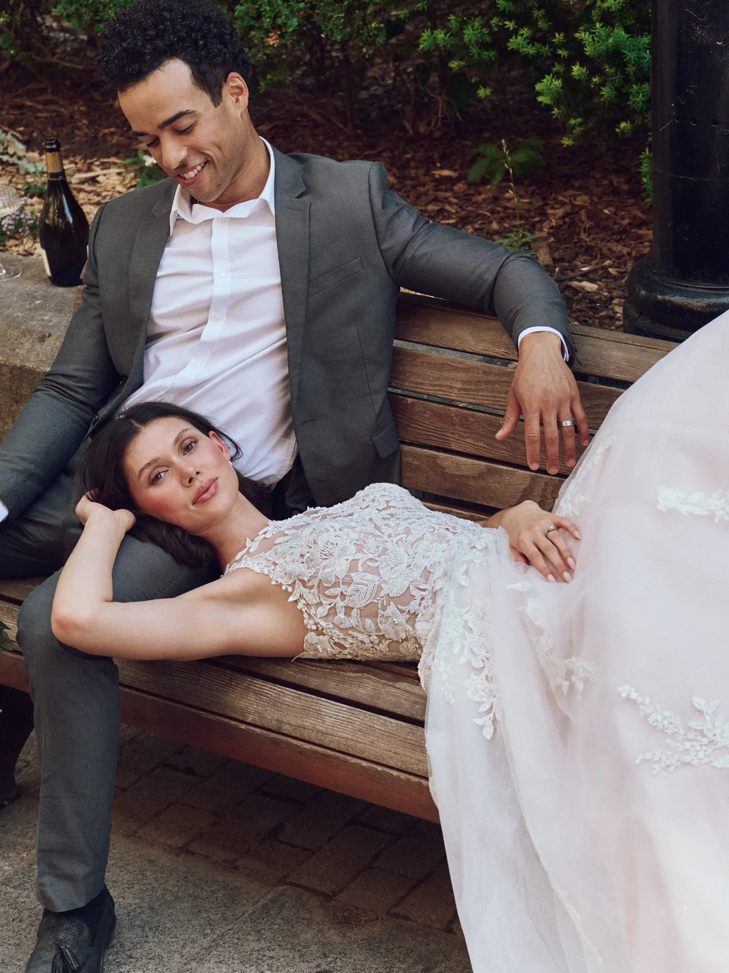 Maggie Sottero Rickie lace A-line dress, side view, bride reclining on groom's lap.