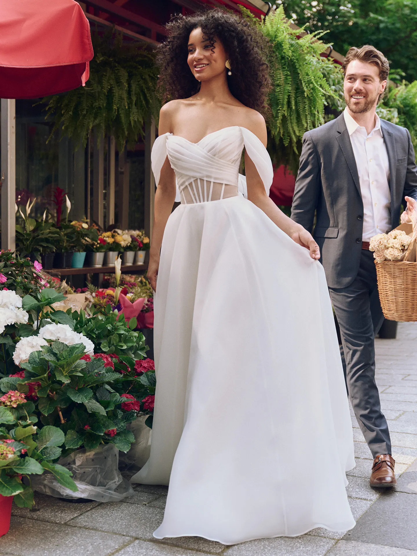 Rebecca Ingram Sunny front view, off-shoulder organza dress, cap-sleeves, outdoor setting