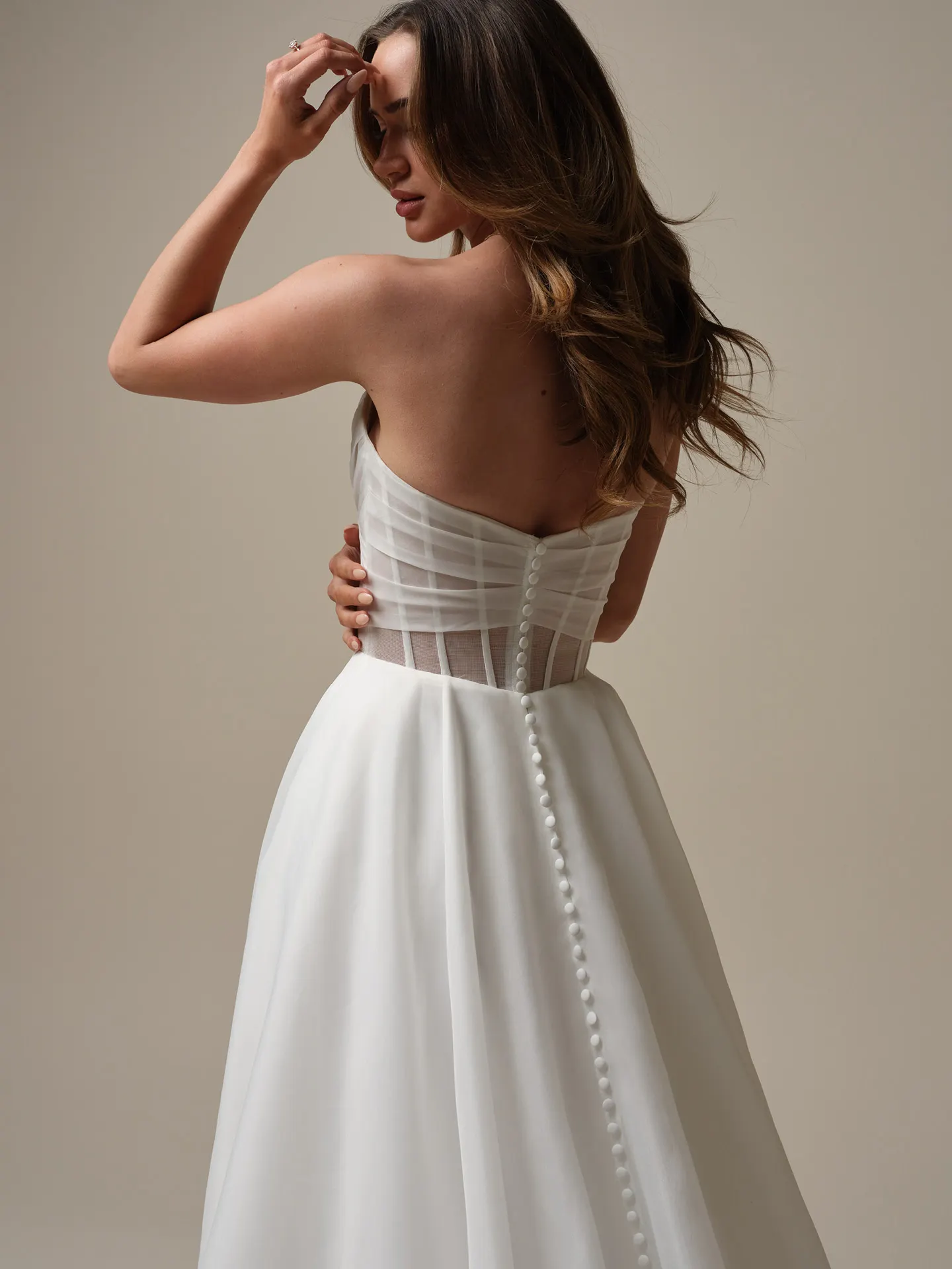 Maggie Sottero Sunny back view strapless A-line gown with buttons