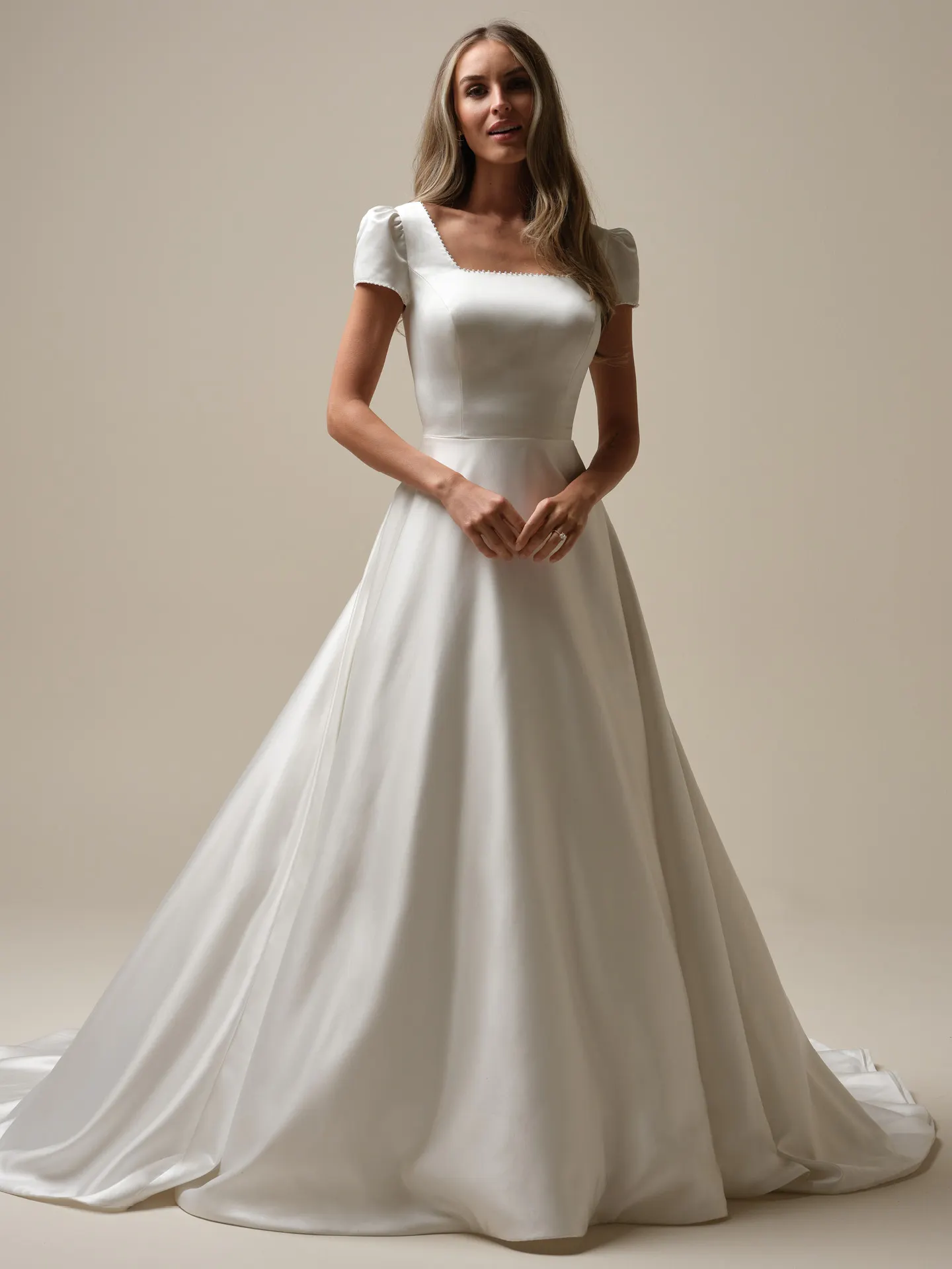 Rebecca Ingram Vesta Leigh front view satin ball gown with puff sleeves.