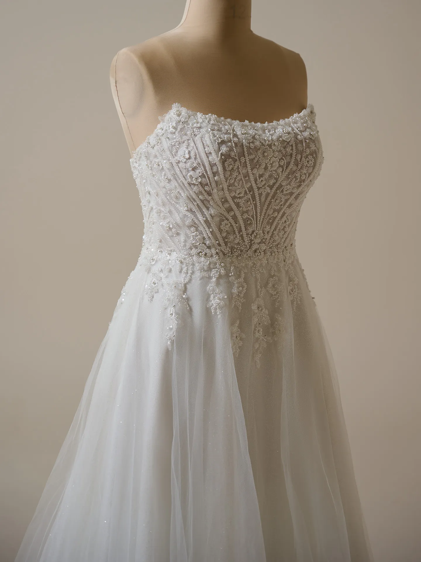 Maggie Sottero Yvette wedding gown front view, sheer organza, shimmering details.