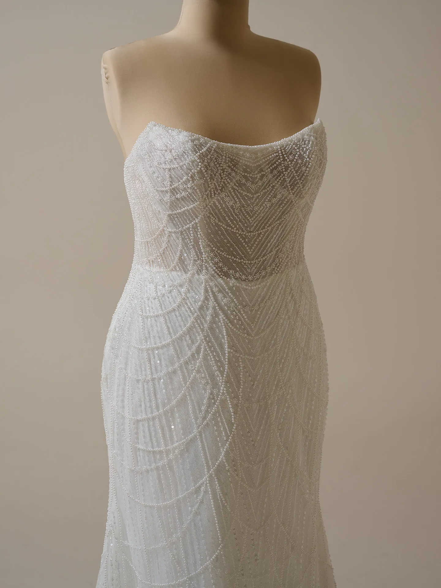 Maggie Sottero Constance sheath gown with draped pearls front view.