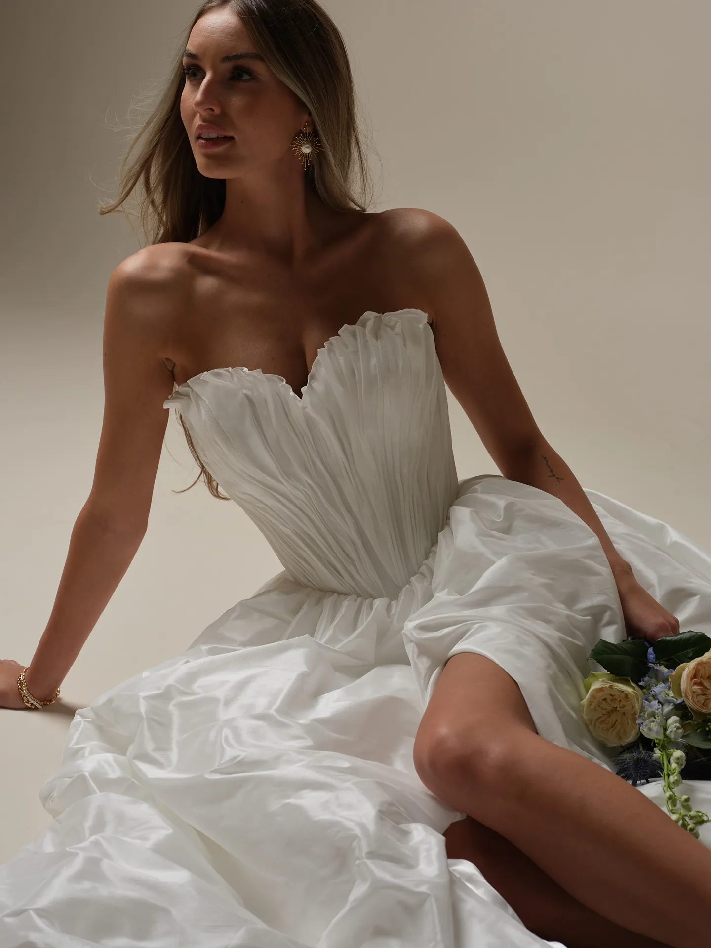 Maggie Sottero Lafayette ruched taffeta bridal dress front view sitting pose