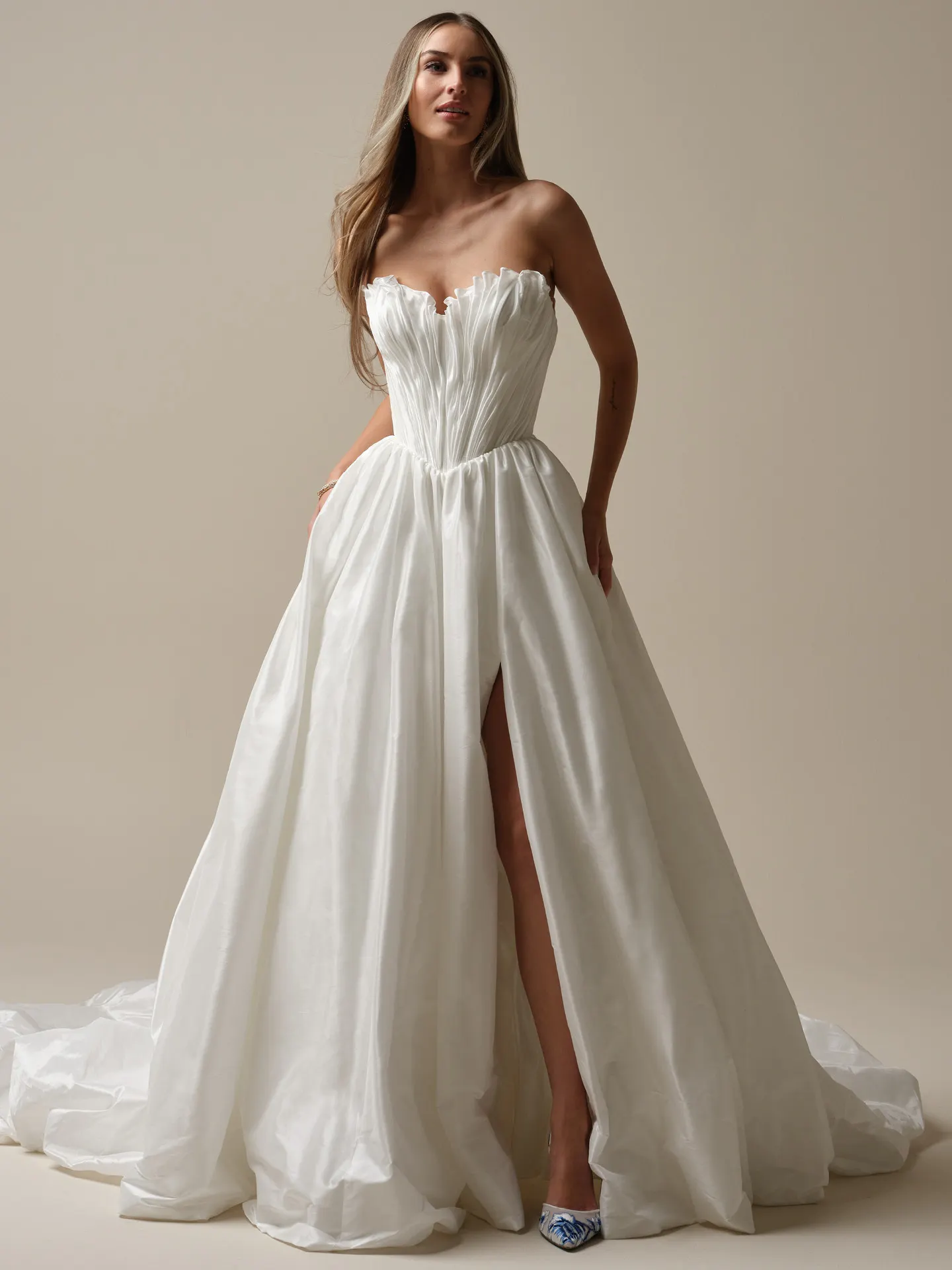 Maggie Sottero Lafayette front view ruched taffeta bridal dress with ruffle detail and side slit